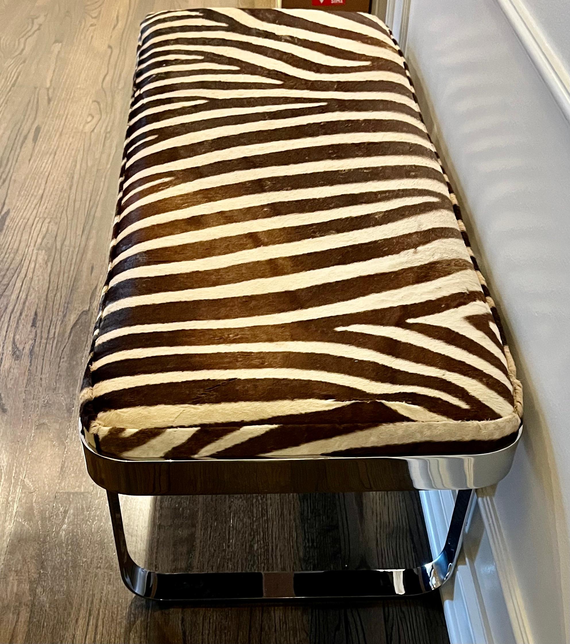 A polished chrome bench manufactured by Tri-Mark and newly upholstered in zebra hide. All in outstanding condition.