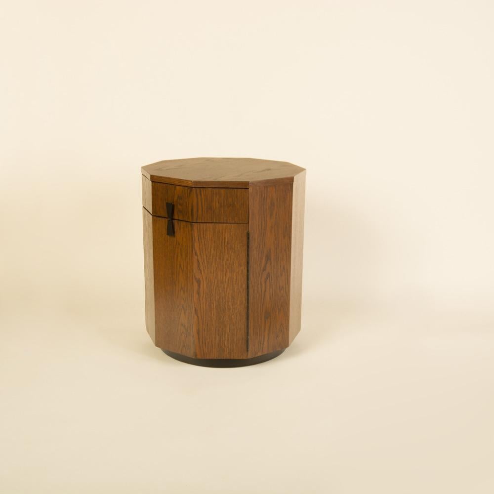 A Midcentury Modern walnut Decagon cabinet by Harvey Probber, circa 1950. With the original label. 
The interior features an open storage space with one top drawer.