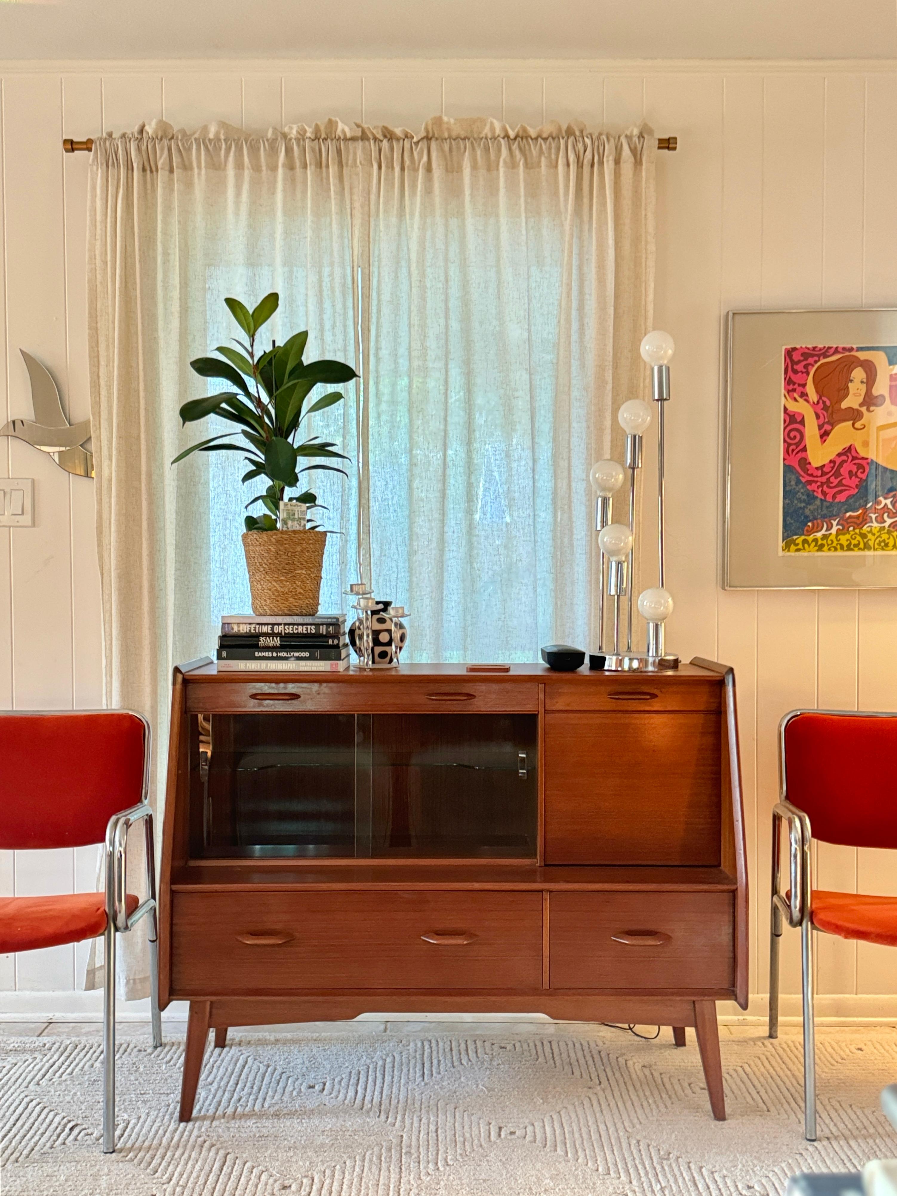 A mid century modern E. Gomme G Plan sideboard/bar cabinet from the iconic Brandon Range, made in the UK circa 1960s. Its sleek, streamlined design captures the essence of mid century modern style. Featuring two spacious drawers, a slim cutlery