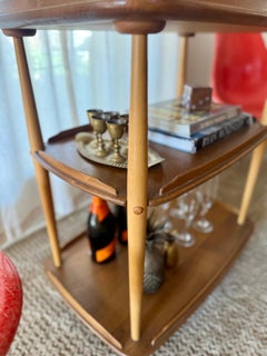 A mid century modern elm and beech bar cart by Ercol & designed by Lucian Ercola