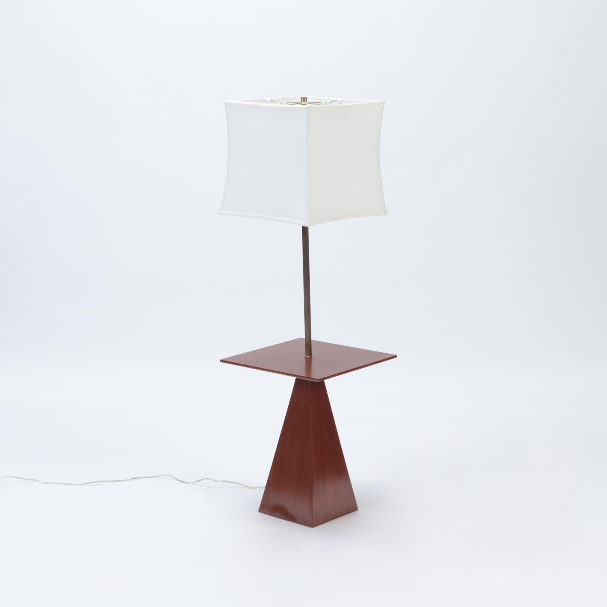 A Mid-Century Modern floor lamp with table base by Harvey Probber, walnut. Circa 1950.