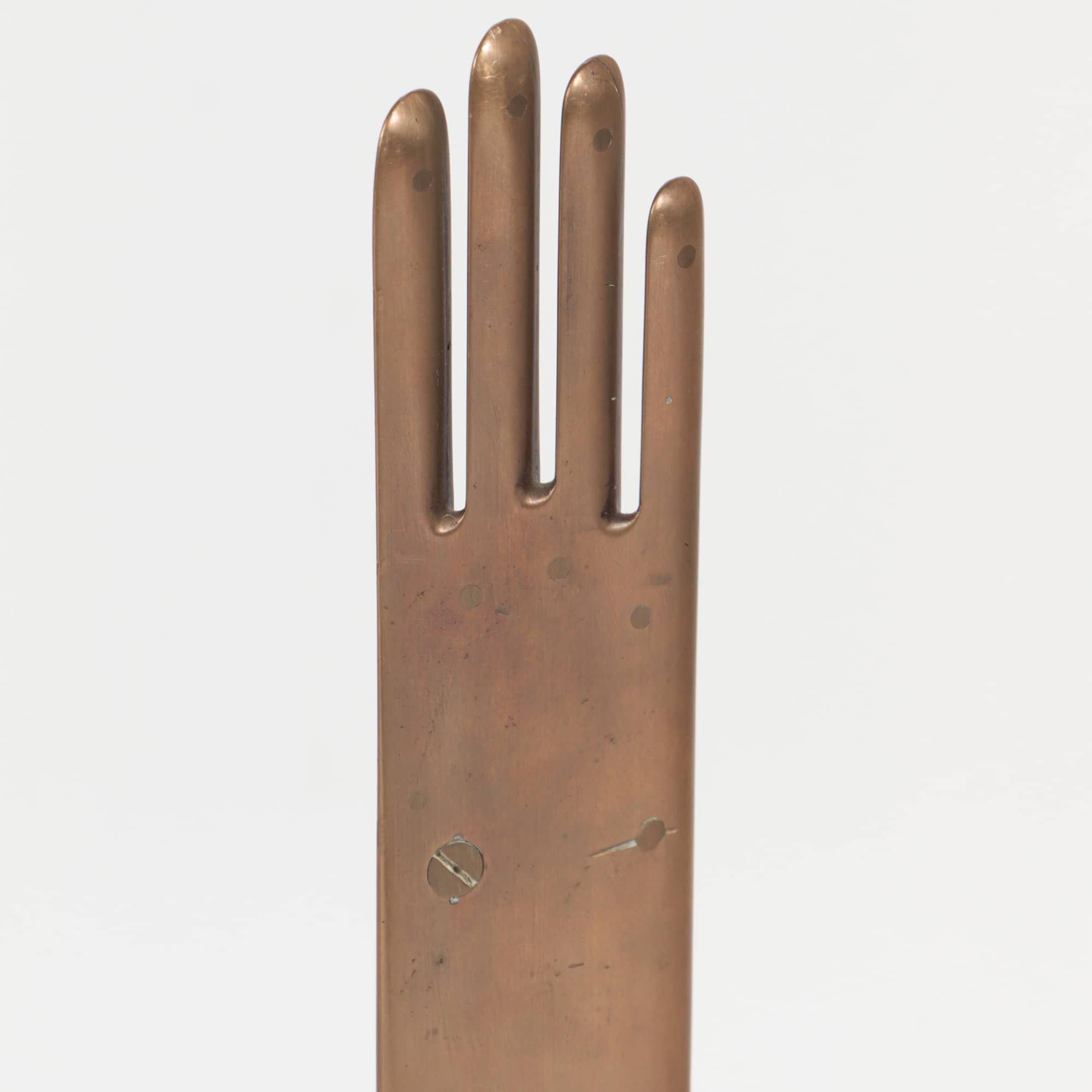A Mid-Century Modern French glove form bronze sculpture, marked Armand Bonnet Crimee Paris.