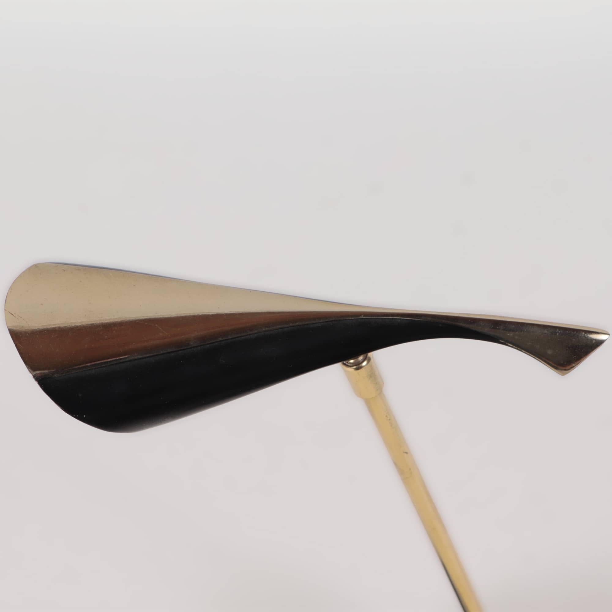 A Mid-Century Modern futuristic black enameled metal and brass Laurel desk lamp circa 1950.