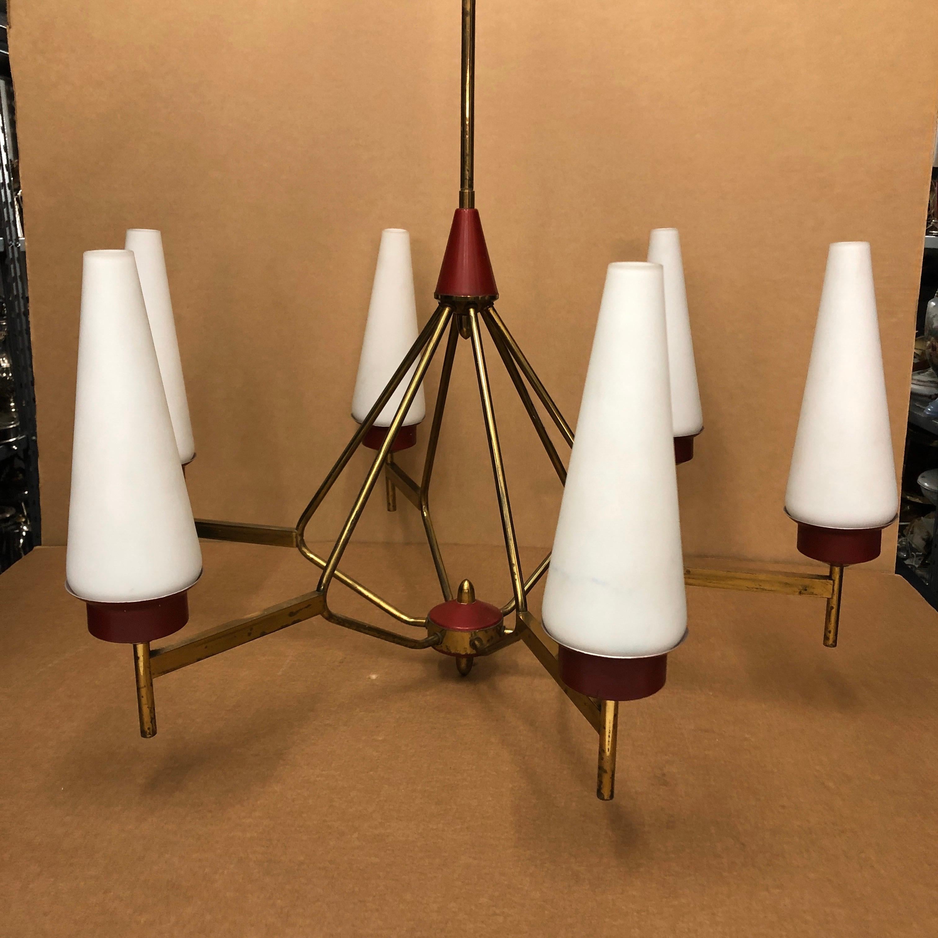 A brass, white opaline glass and red painted metal six-light chandelier. Brass is in original patina, it works 110-240 volts and needs regular e14 bulbs.