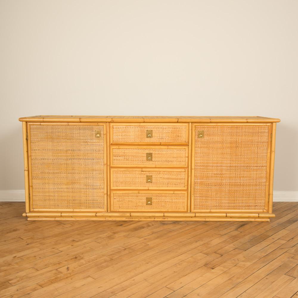 A Midcentury Modern Italian rattan sideboard with four drawers, two doors and brass hardware circa 1950.