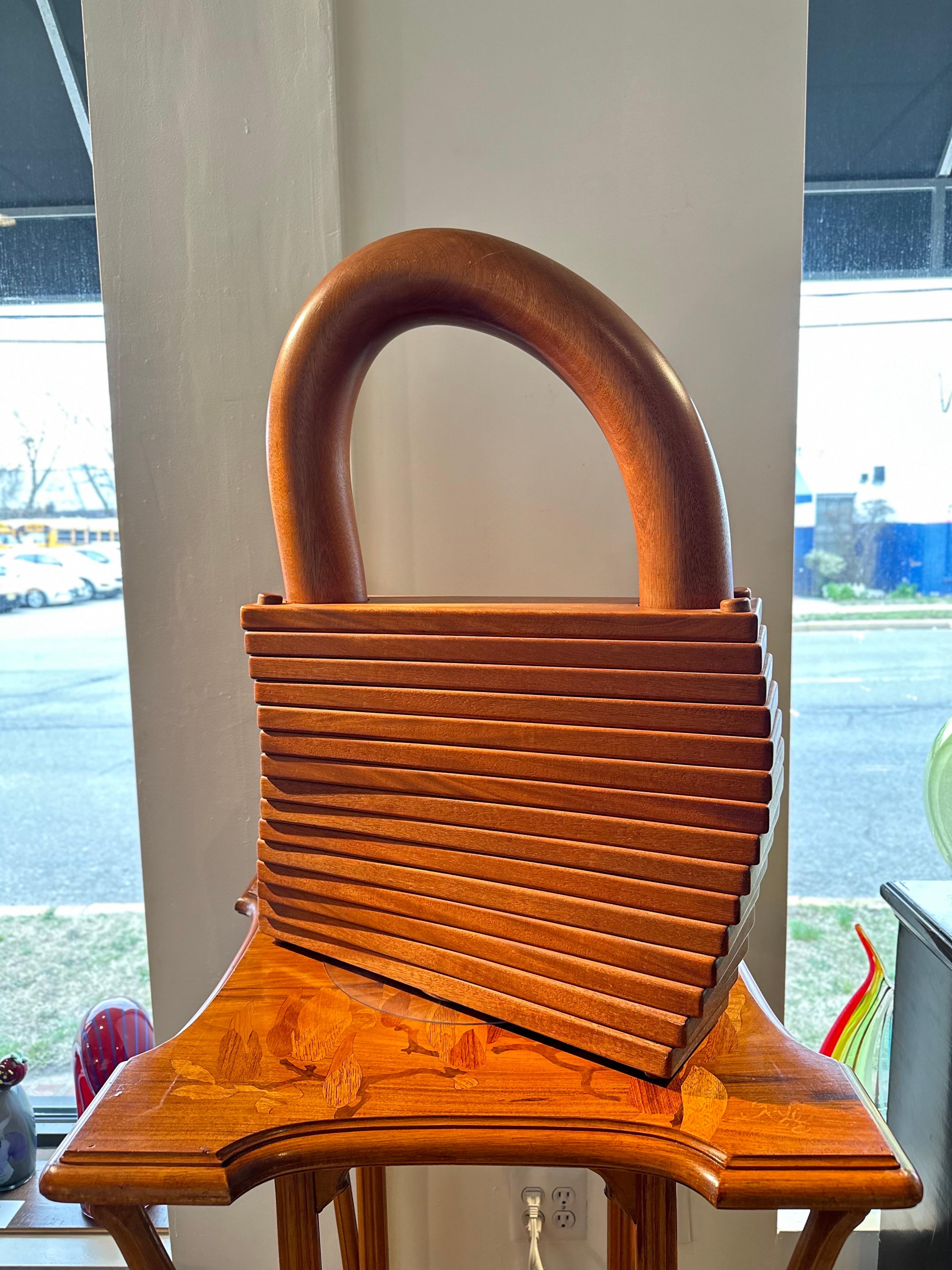 A Monumental American Mid Century Modern Studio Craft carved solid wood sculpture of a pad lock. The sculpture is large in scale. The pad lock is very detailed in its look and appearence and is highly detailed down to the key hole on the underside.