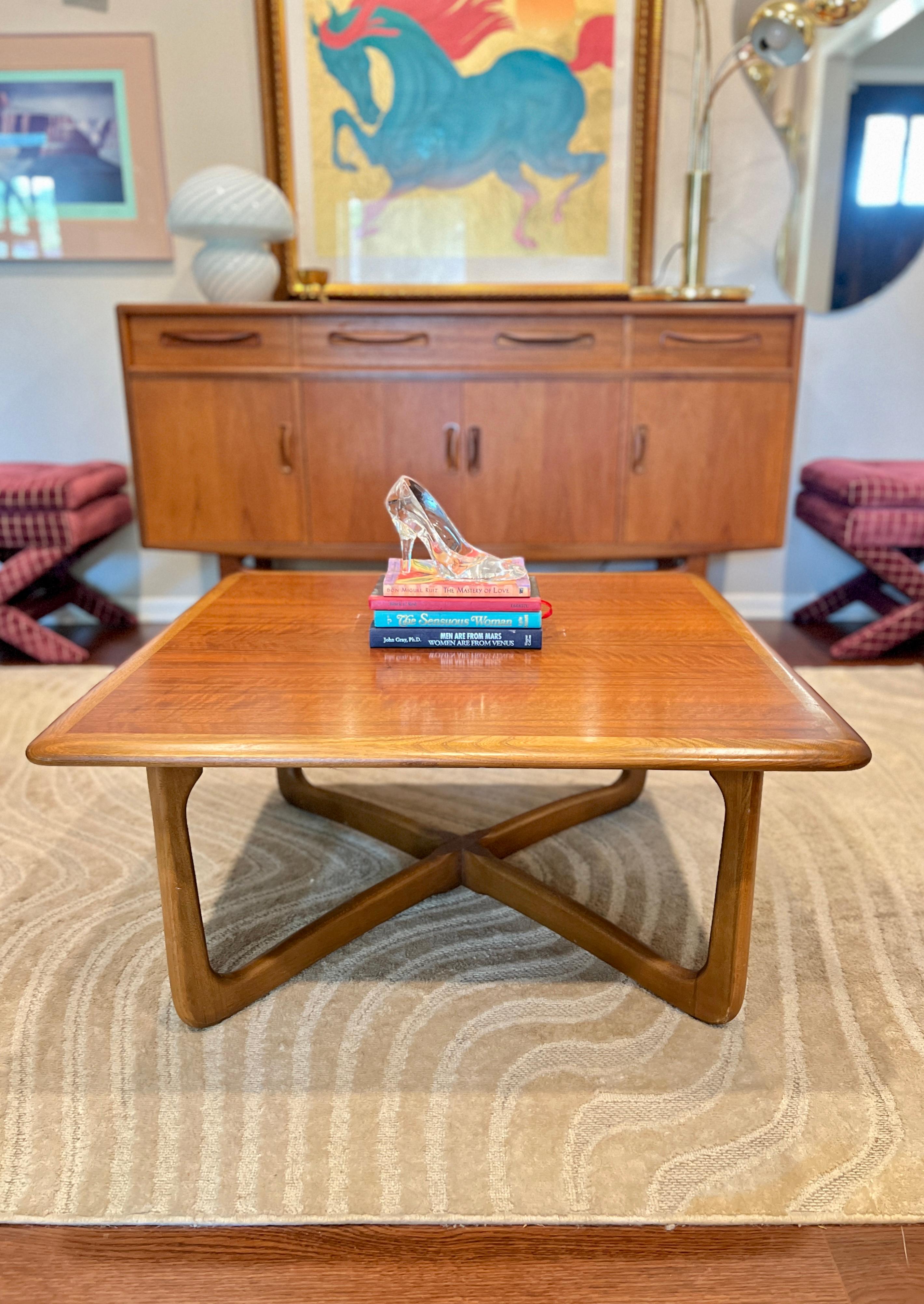 A mid century modern coffee table by Lane, with a beautiful wood grain on top and cross base. I had the matching side tables when I first started Lich Goods in 2021. This coffee table is in very good condition with one repair on just one leg as seen