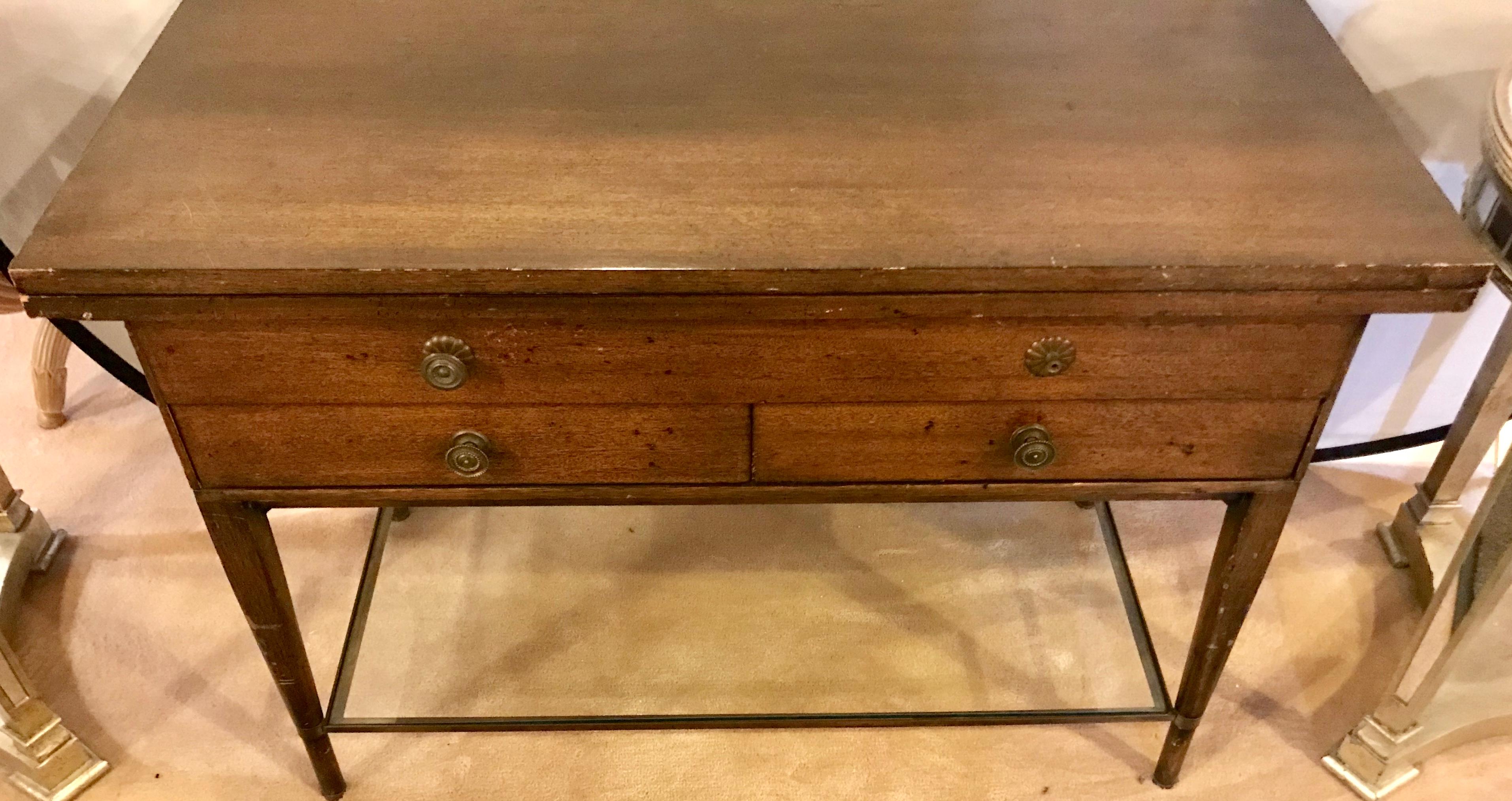 A Mid-Century Modern Paul McCobb flip top server game or small dining table having a lower glass shelf. All original bearing label. The depth is 20