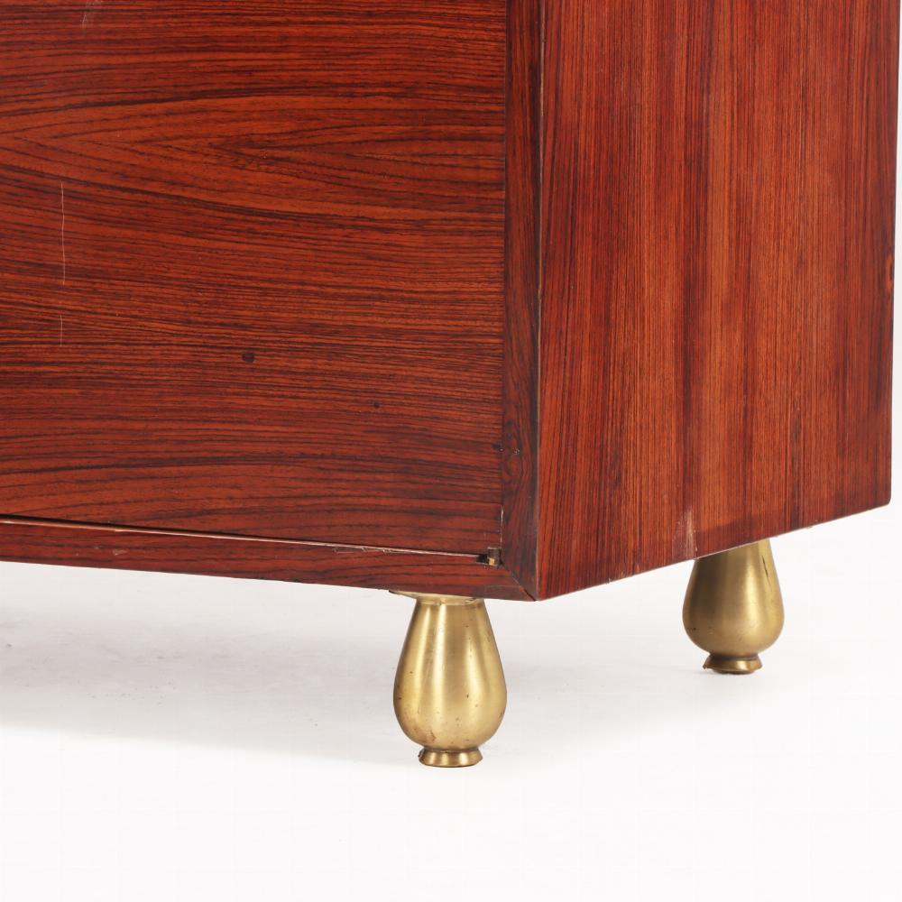 This elegant and functional storage piece has four doors opening to a fitted interior with five drawers flanked by shelves. The case is raised on  short bulbous, bronze legs. A wonderful addition to your MCM or contemporary interiors in the dining