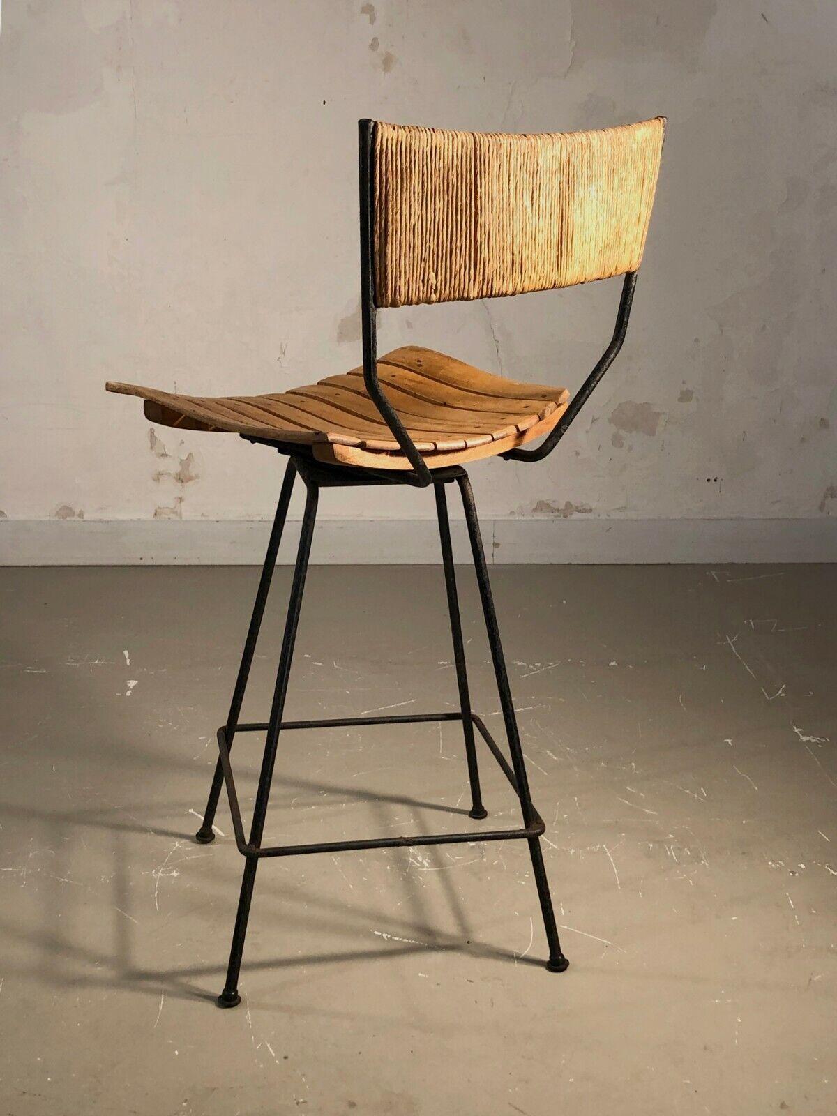 An astonishing high bar chair with adjustable seat, Modernist, Free Form, Dansk, Scandinavian, black lacquered wrought iron structures, swivel seat on its axis in strips of folded wood, straw back, by Arthur Umanoff, produced by Raymor, USA