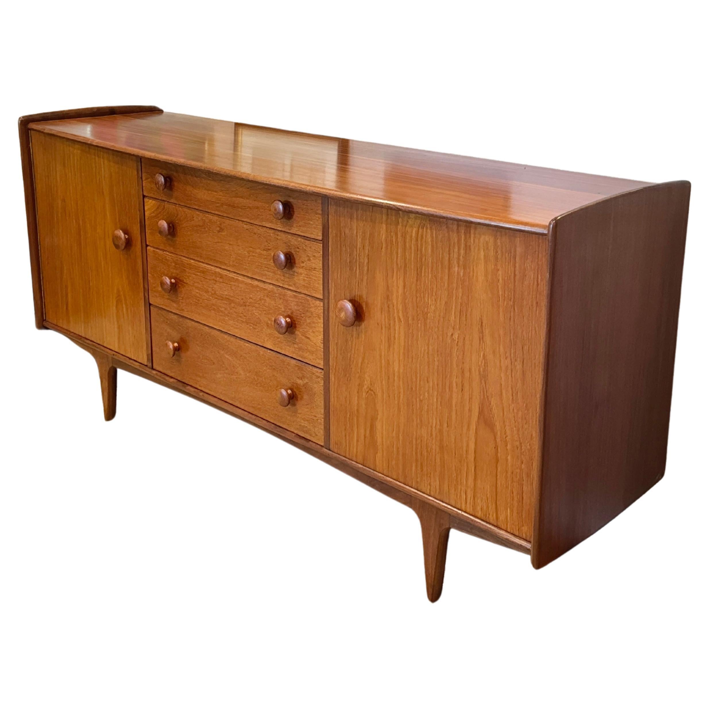 A mid century modern solid teak credenza designed by John Hebert for Younger