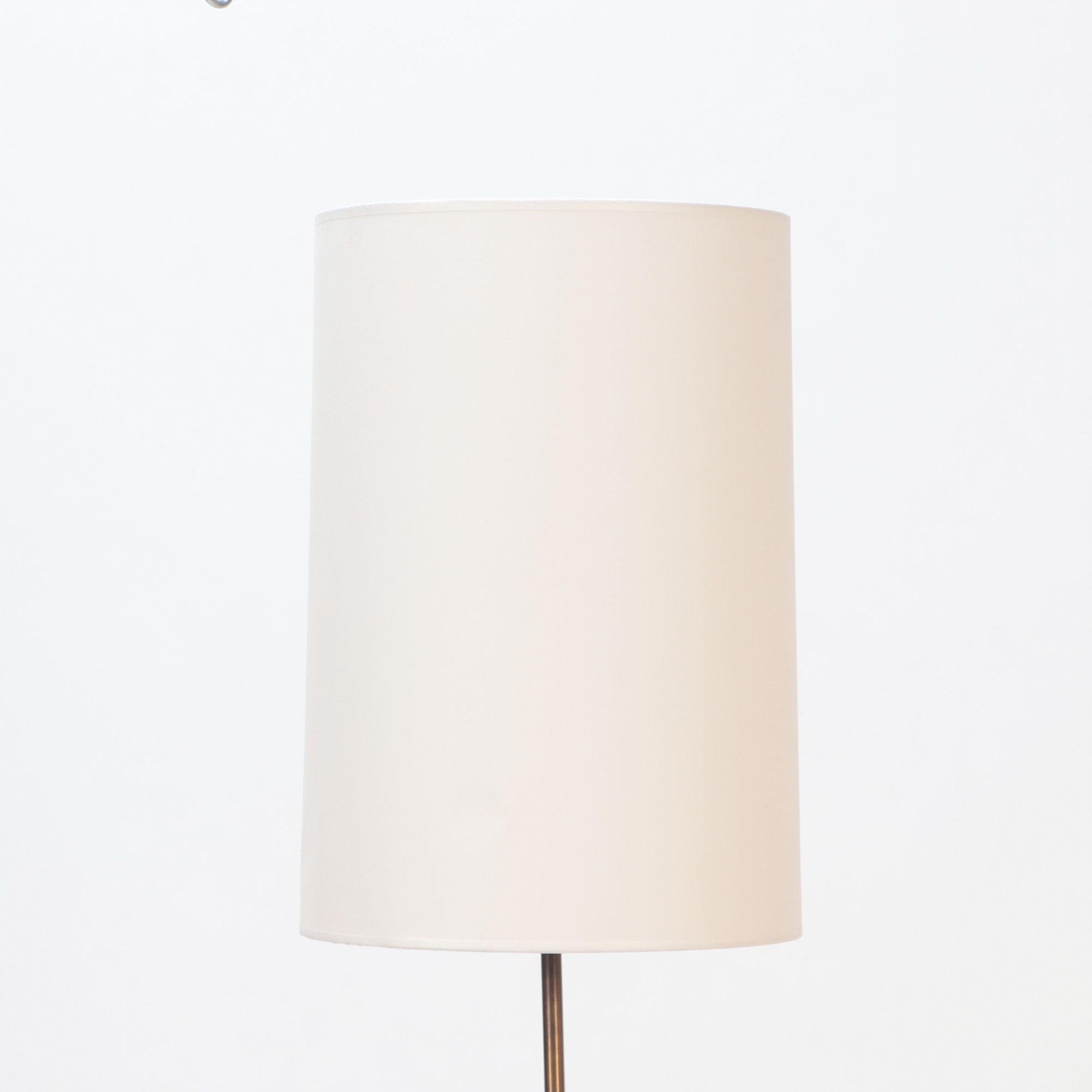 A Mid-Century Modern Swedish floor lamp on a glass base. Brass with wooden details. C 1950.