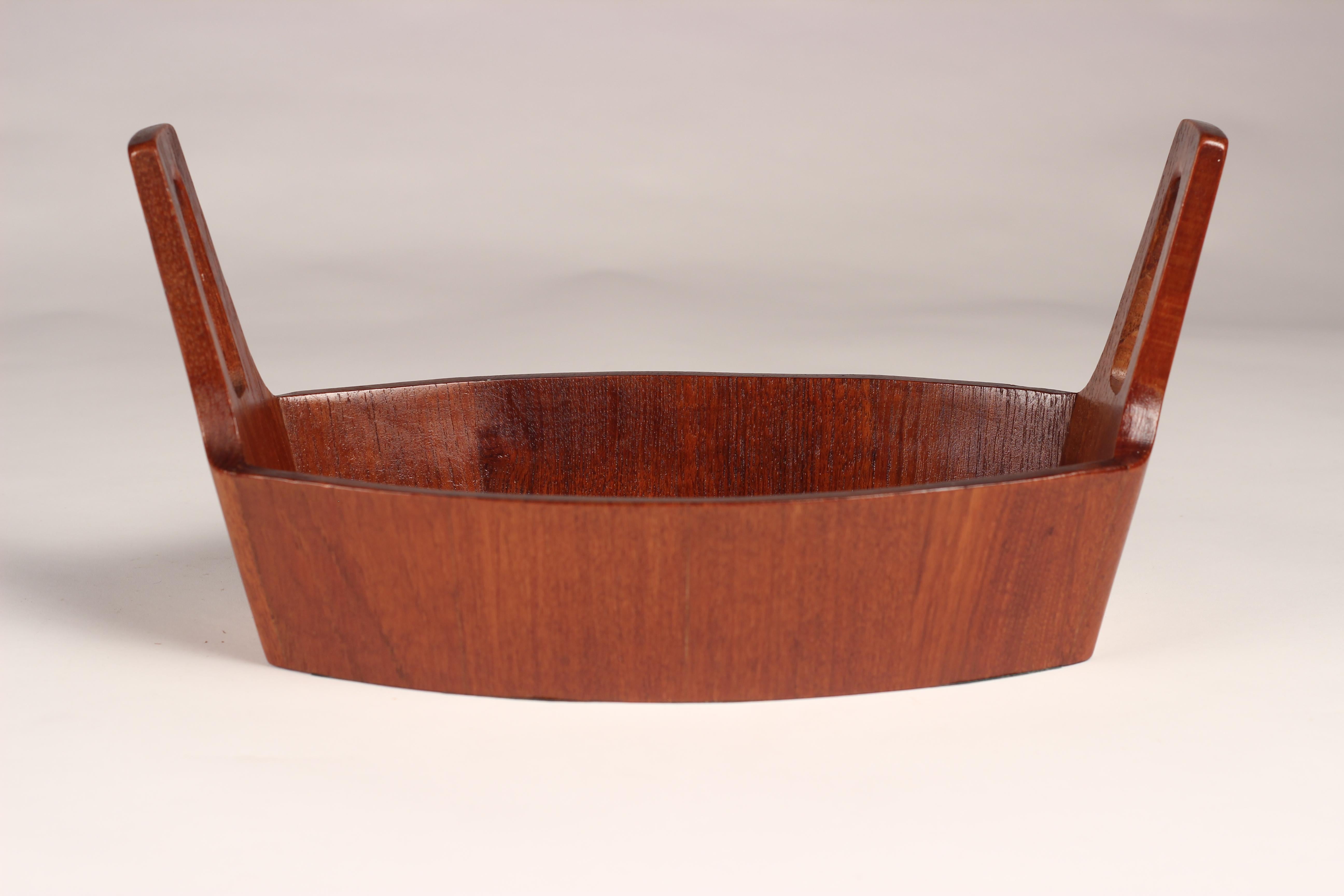 A midcentury staved teak boat shaped bowl in the style of Jens Quistgaard. This piece is one of a collection we have collected and restored by the Italian Maker Arni Form. Stamped to the base with the original copper mark and logo.