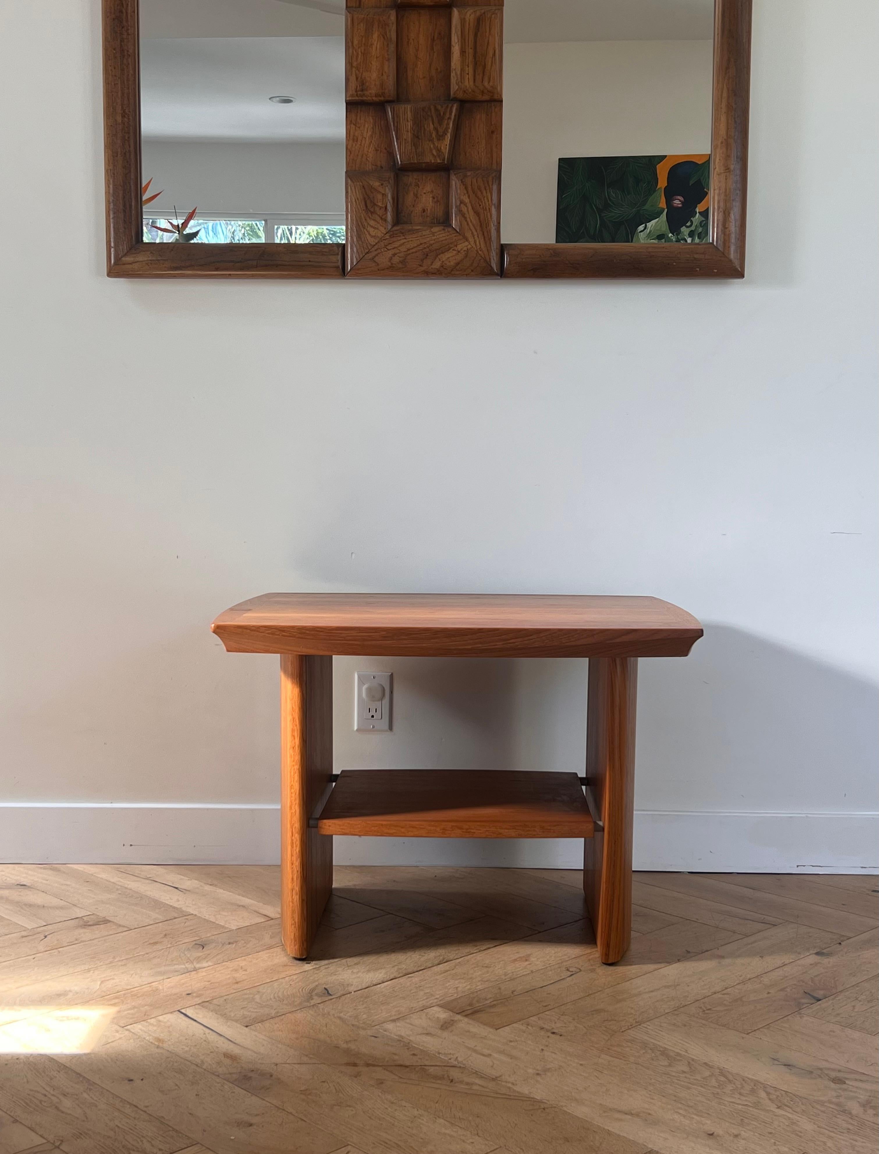 A classic mid century modern teak wood side or cocktail table by Nordic Furniture, circa late 1960s. Gorgeous rich wood grain, interesting lines (the top bulges a little, so measurements were taken from the widest and deepest parts), and furnished