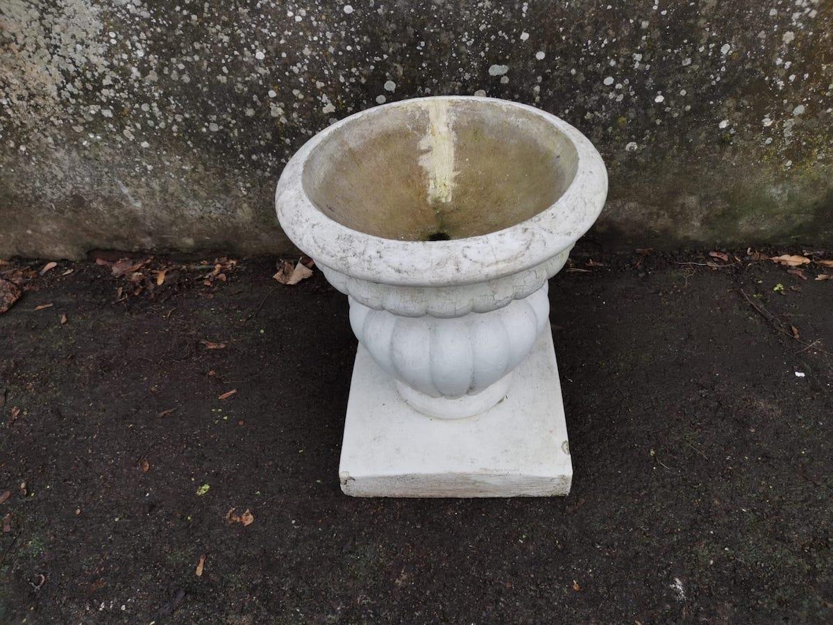 A Mid-Century Modern two-piece French Classical concrete bulbous and fluted planter on stand.
Upper planter part has split in two at some point in it's life, and has also been professionally repaired a long time ago.