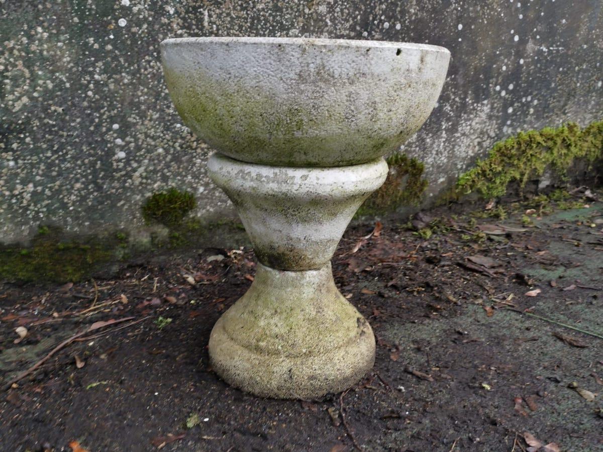 A Mid-Century Modern two-piece Modern French concrete hour glass style planter on stand with nice light even patina.