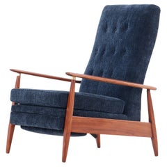 A mid century modern upholstered Milo Baughman model #74 walnut reclining chair.