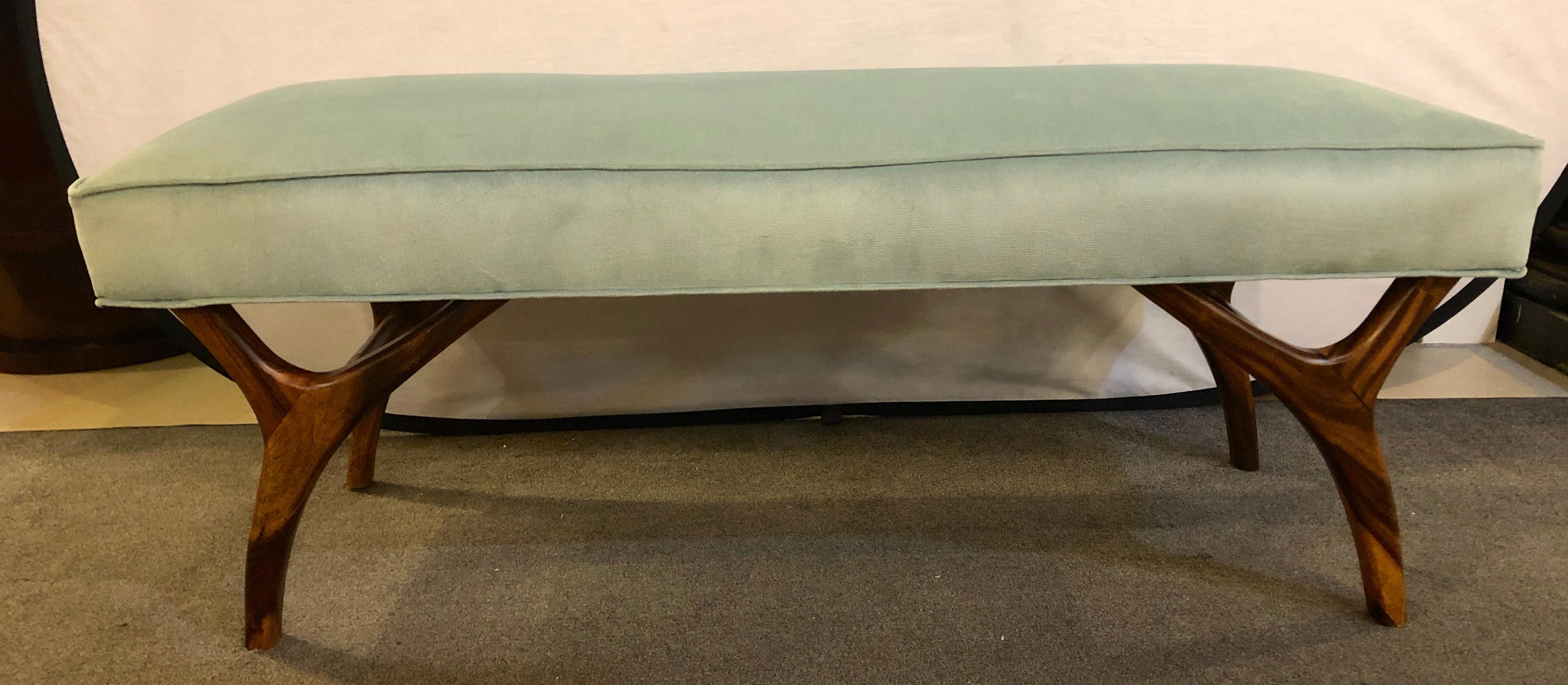 A Mid-Century Modern window bench or footstool in new upholstered on sprayed legs.