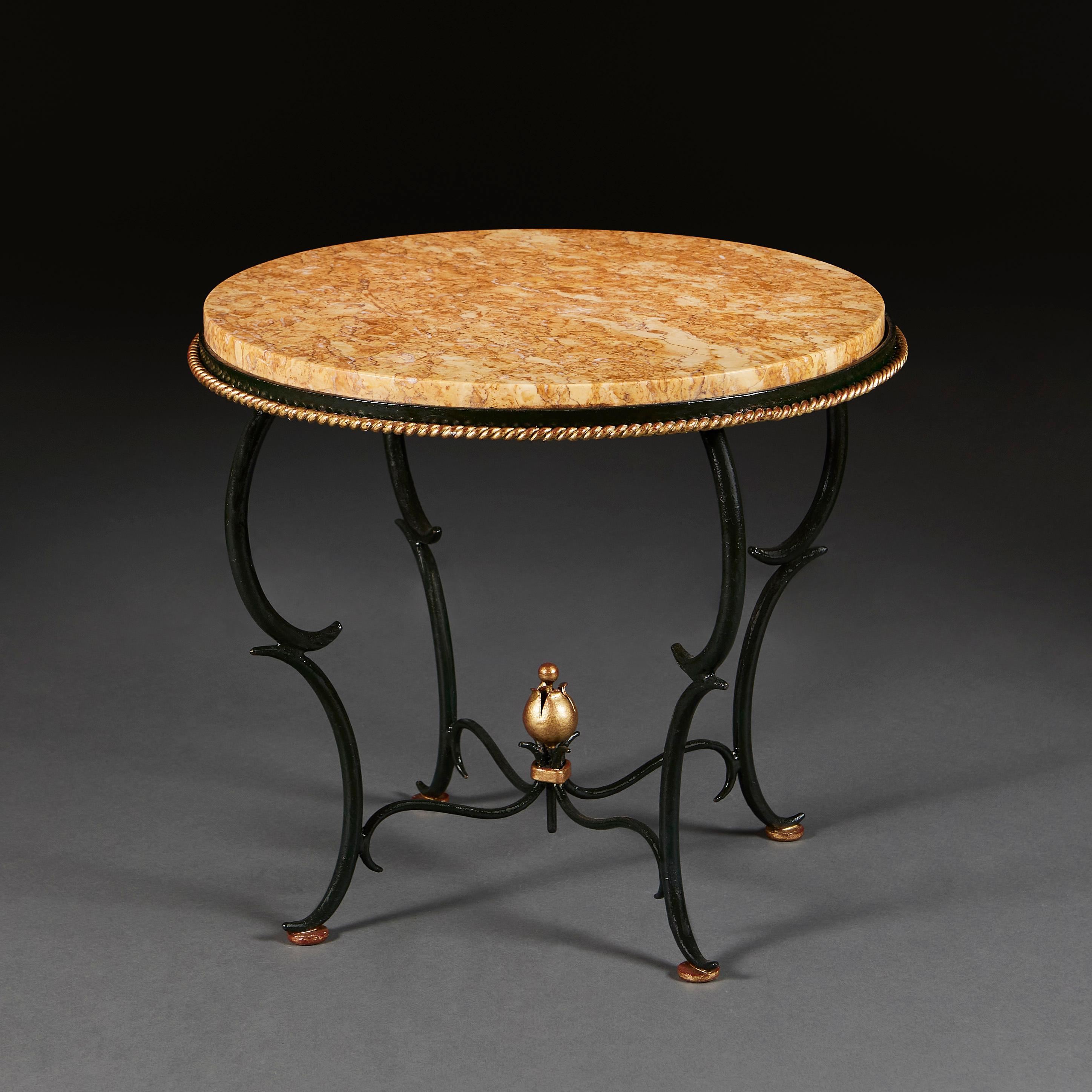France, circa 1940  

A mid 20th century circular gueridon table with inset sienna marble top, with cross stretcher terminating in a gilded flower head. In the manner of Gilbert Poillerat.

Height 45.50cm
Diameter 53.00cm