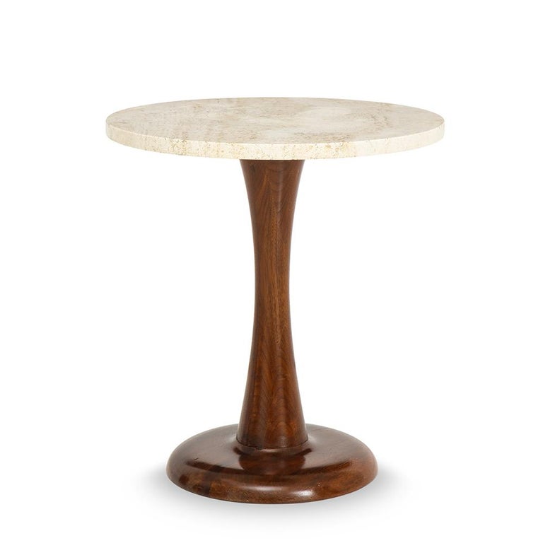 A mid-century round coffee table with a walnut base and travertine top, circa 1950.
 