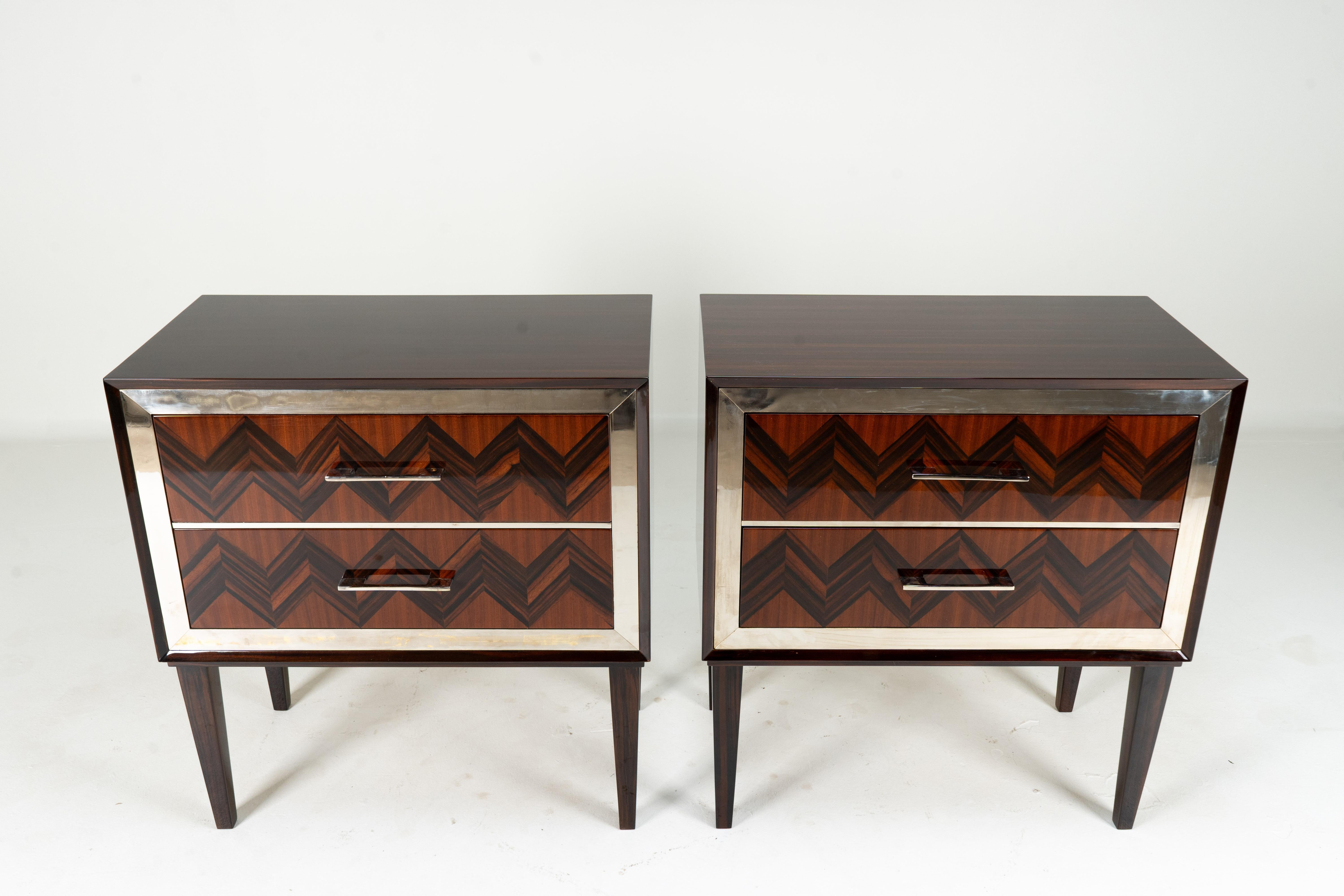 The simple and solid casework of these chests of drawers is enlivened by dramatic brass trim along the edges of the drawers and brass plated handles. The highly polished wood veneer is macassar, a type of ebony. The chest is Hungarian made, based on