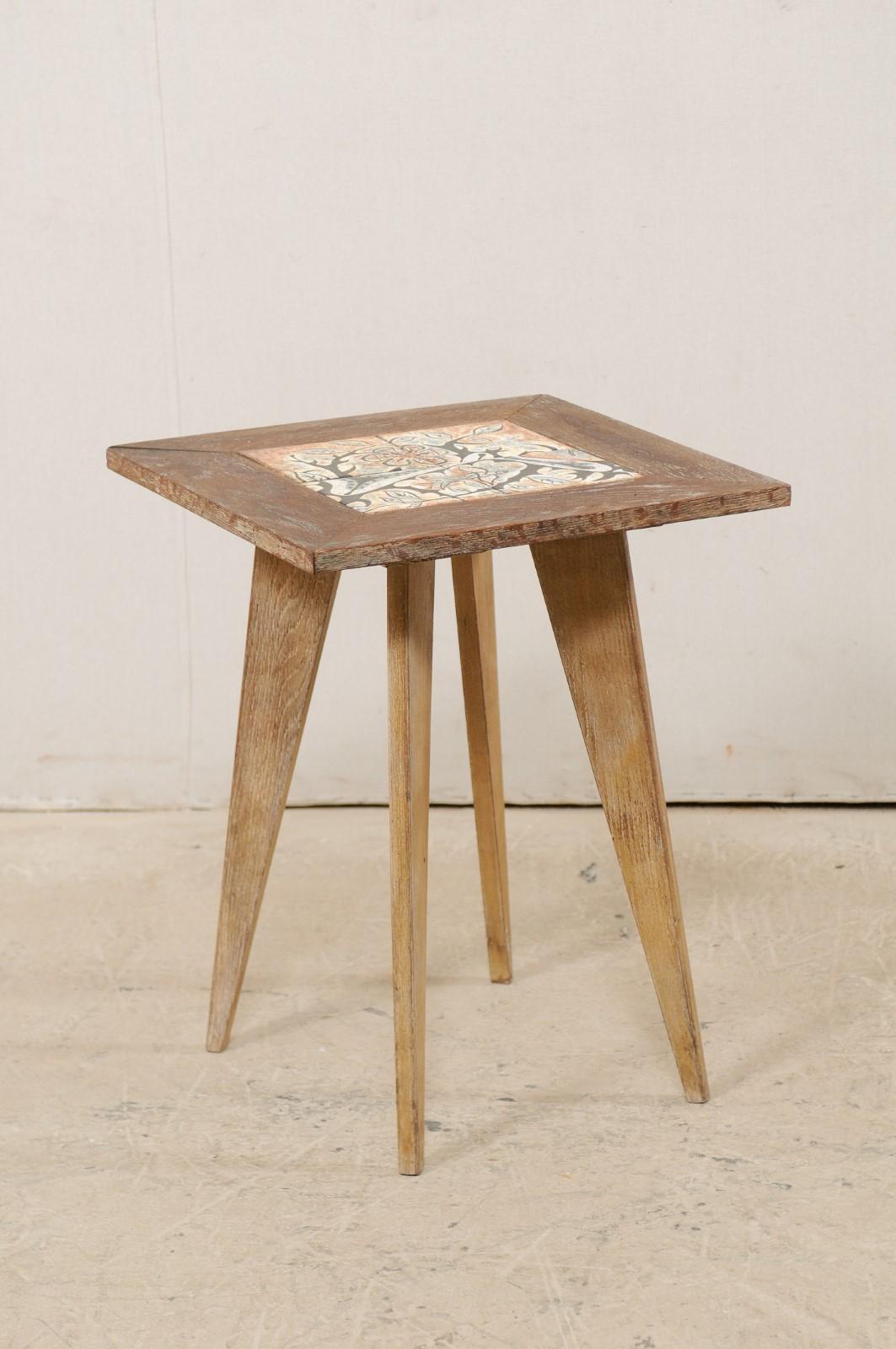 A 1960s American side table with artisan tile top attributed to painter and muralist Anton Refreiger (March 20, 1905-October 10, 1979) this vintage side table, with its 20