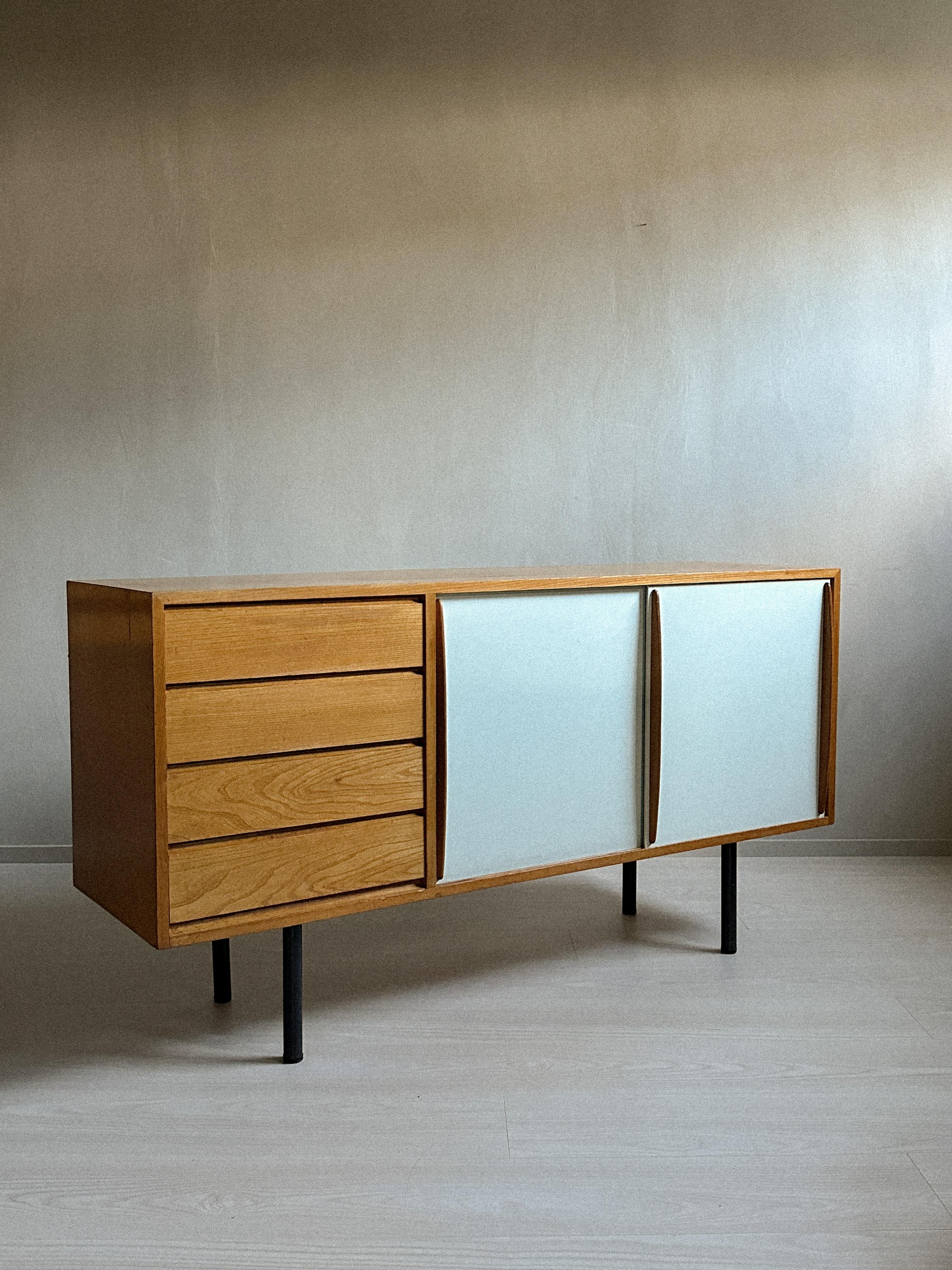 A wonderful sideboard by Finish designer Olli Borg. Model 4004 for Asko, Finland c. 1950s. A set of 4 drawers, 2 sliding doors and shelving interior, metal legs. Length 150 cm, depth 43 cm, height 80 cm. 

Wear consistent with age and use. 