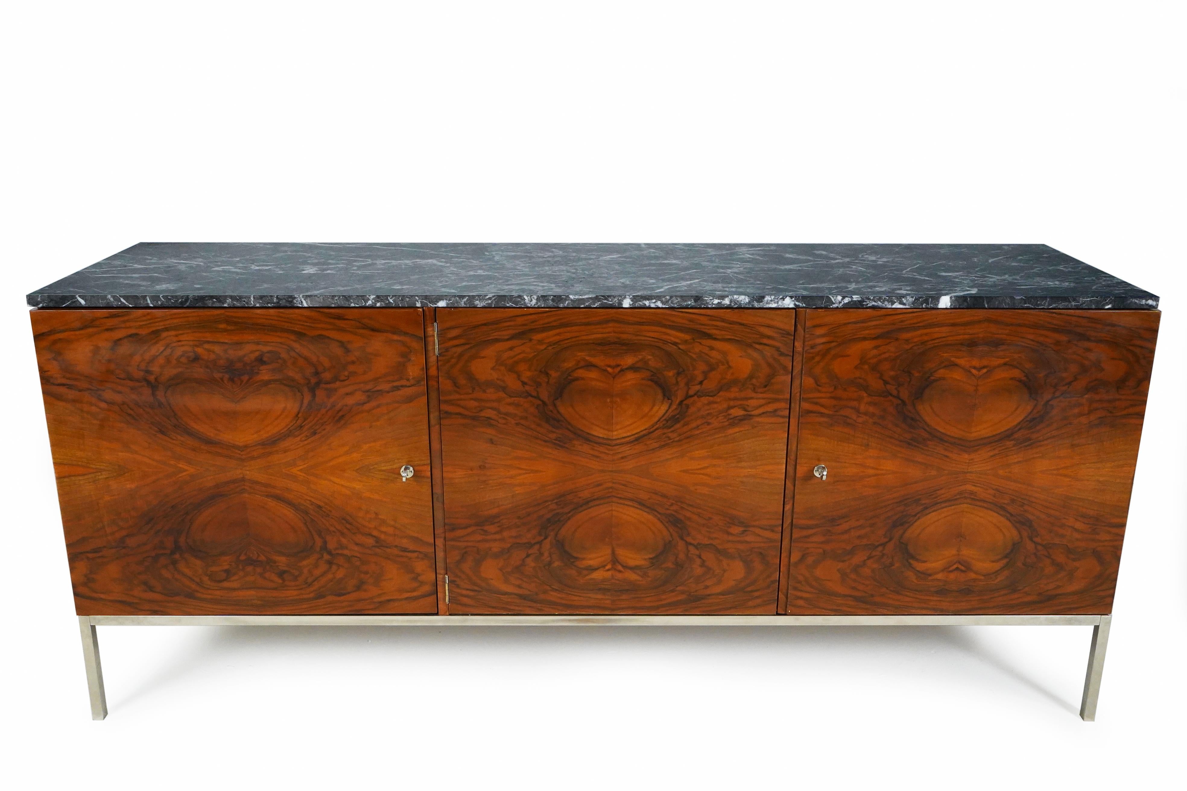 A fine midcentury sideboard made with book-matched walnut veneer doors, a beautifully-veined marble top and steel frame. This is a fine example of Minimalist design executed with fine materials, meticulously assembled. The veneer sheets are bold in