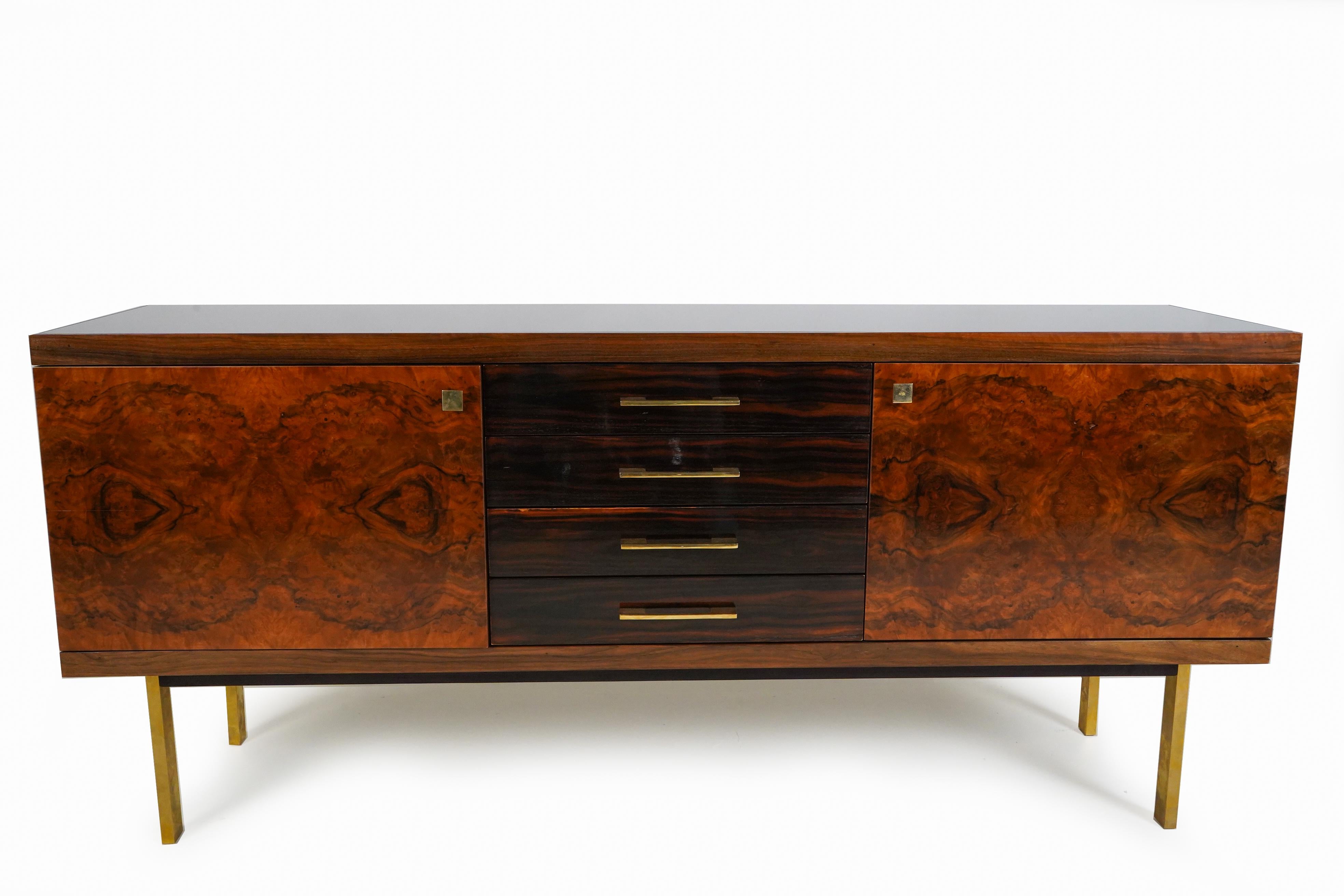 This sophisticated sideboard straddles the categories of Art Deco and Mid-century modern. It was made in a small atelier in Budapest, Hungary that has operated since the early 1900's. The distinctive aspect of the piece is its rich use of