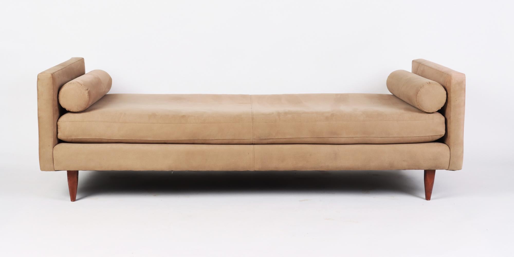 A Mid Century style day bed, tapered legs and plush, blend down cushions.
Beige suede upholstery.