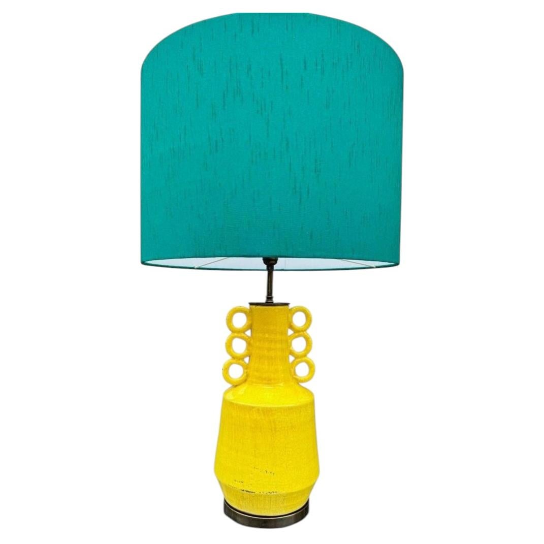 A mid century style yellow ceramic and bronze lamp with six handle design. For Sale