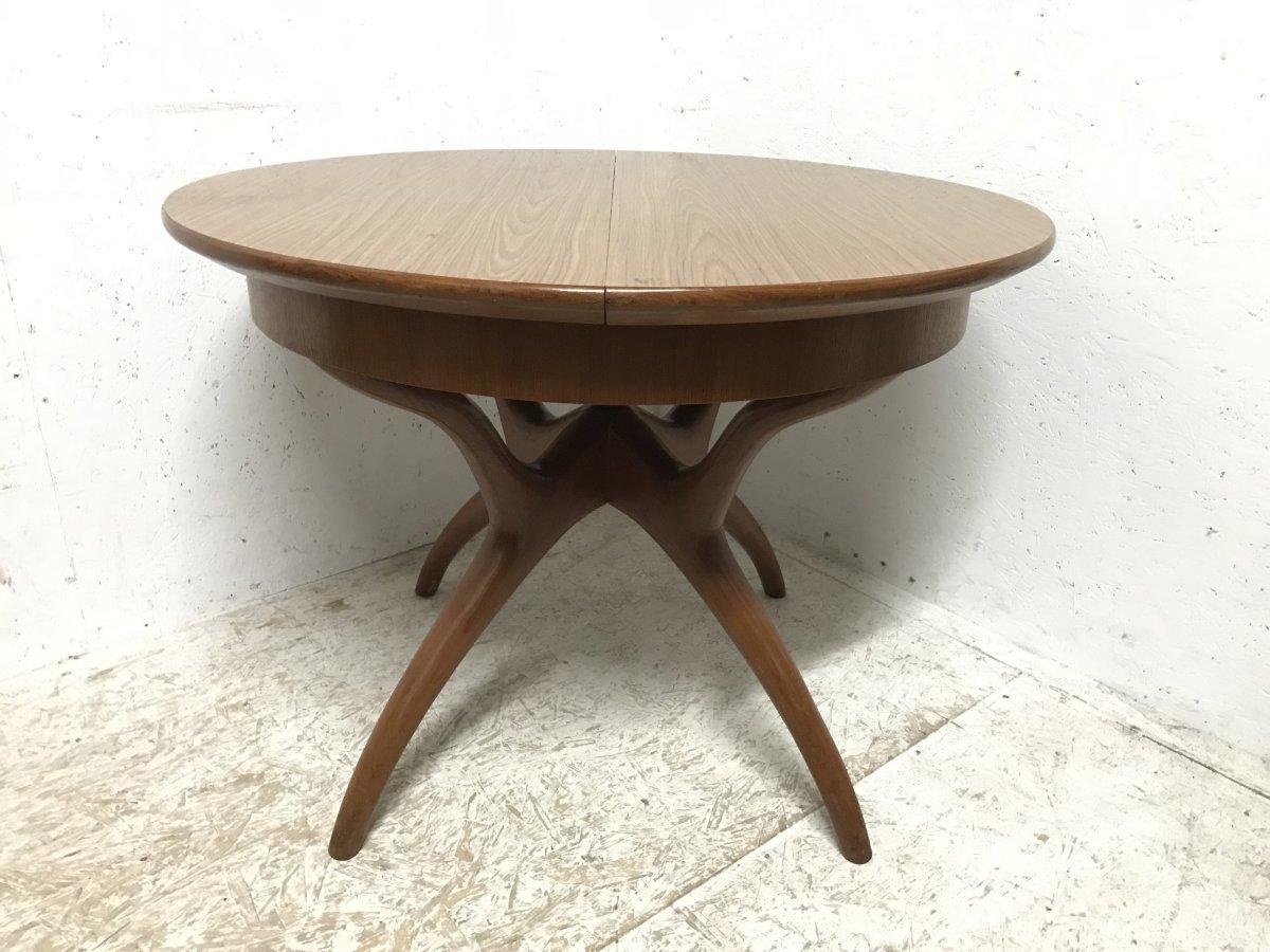 A good quality midcentury teak extending dining table with a fixed fold up extra leaf that folds neatly back before the table is pushed back together on stylish Organic cross frame legs.
Measures: Height 30 inches, width closed 41.5 inches, width