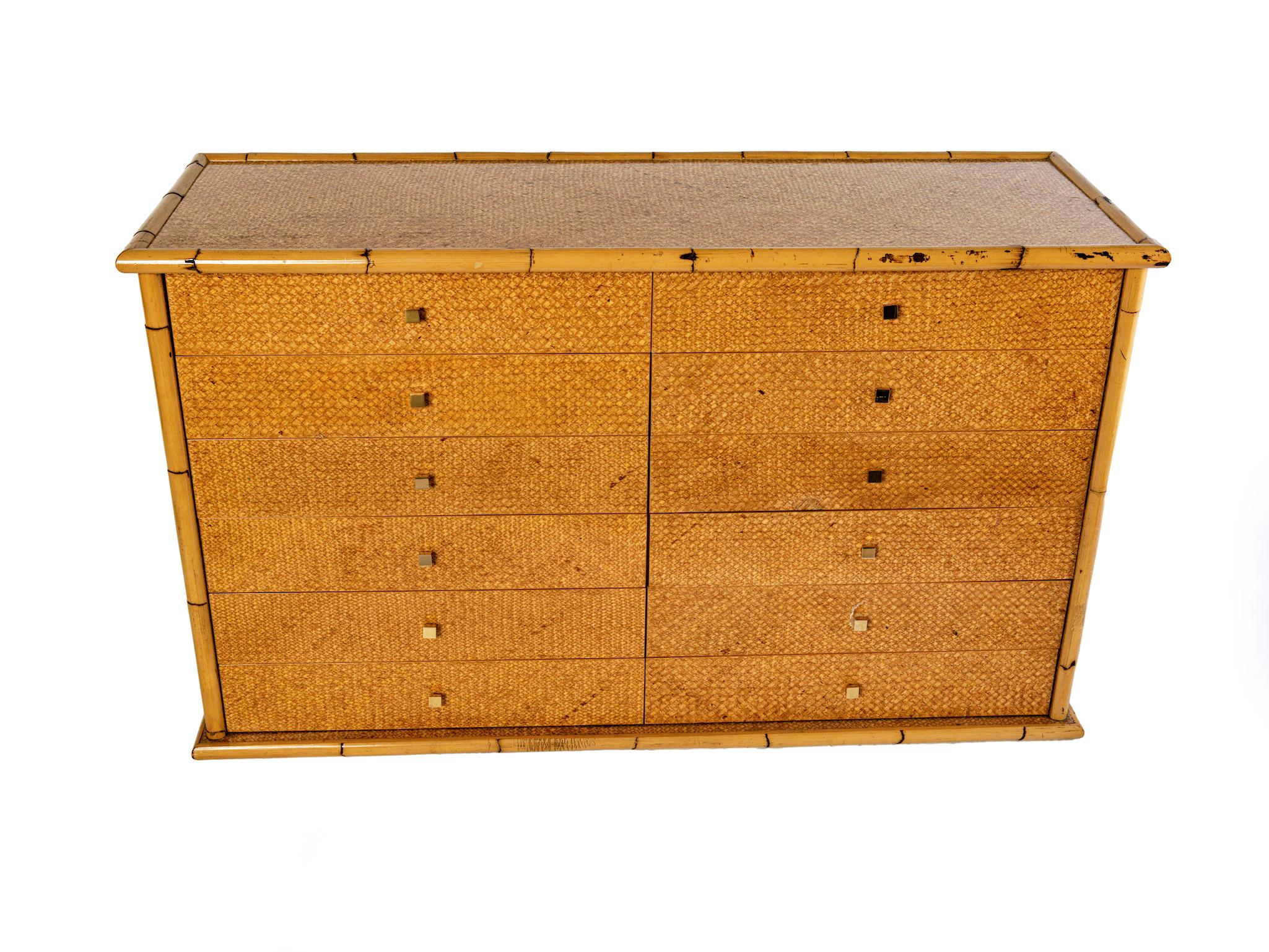 An Exceptional mid century twelve-drawer rattan sideboard with brass knob handles. It would be great in a dining room or pantry to store utensils, or as server.