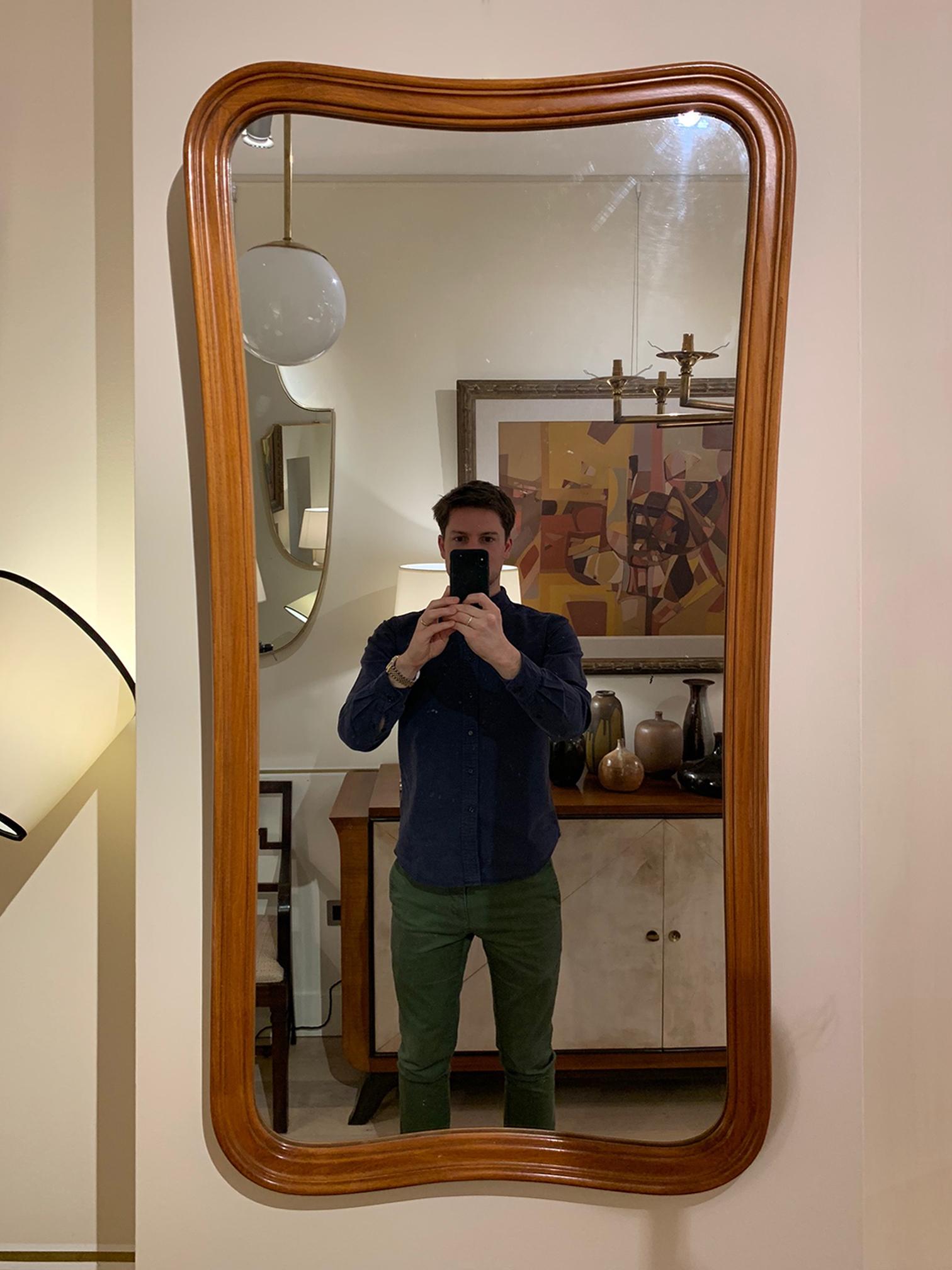 A mahogany mirror, of undulating form
Sweden, circa 1950.