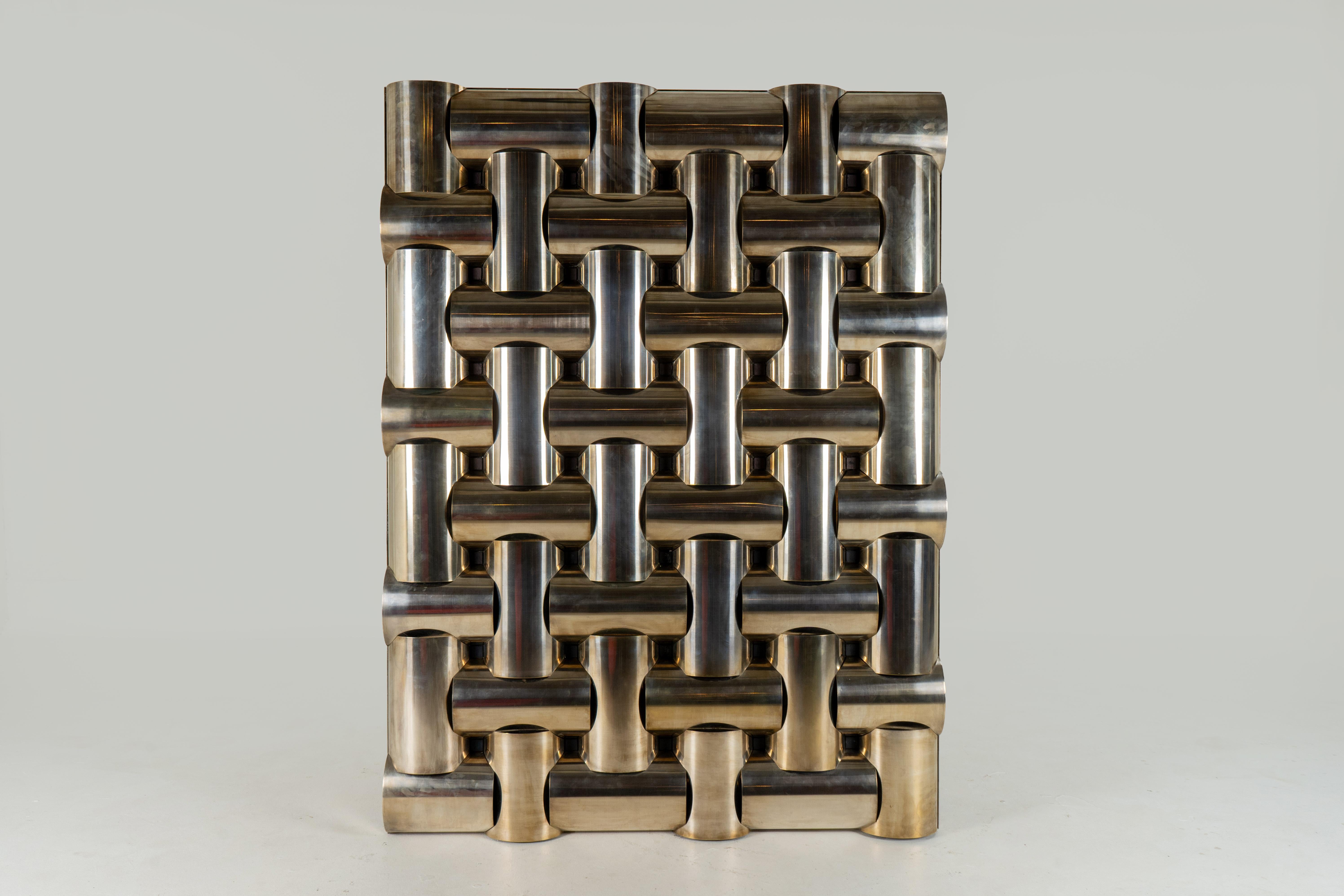 This is an exceptionally bold and arresting piece of metal wall art. Dating to the 1960's, this interlocking, hatched design is made from polished stainless steel. Despite the inherent weight of the material, it can be hung on any wall with the