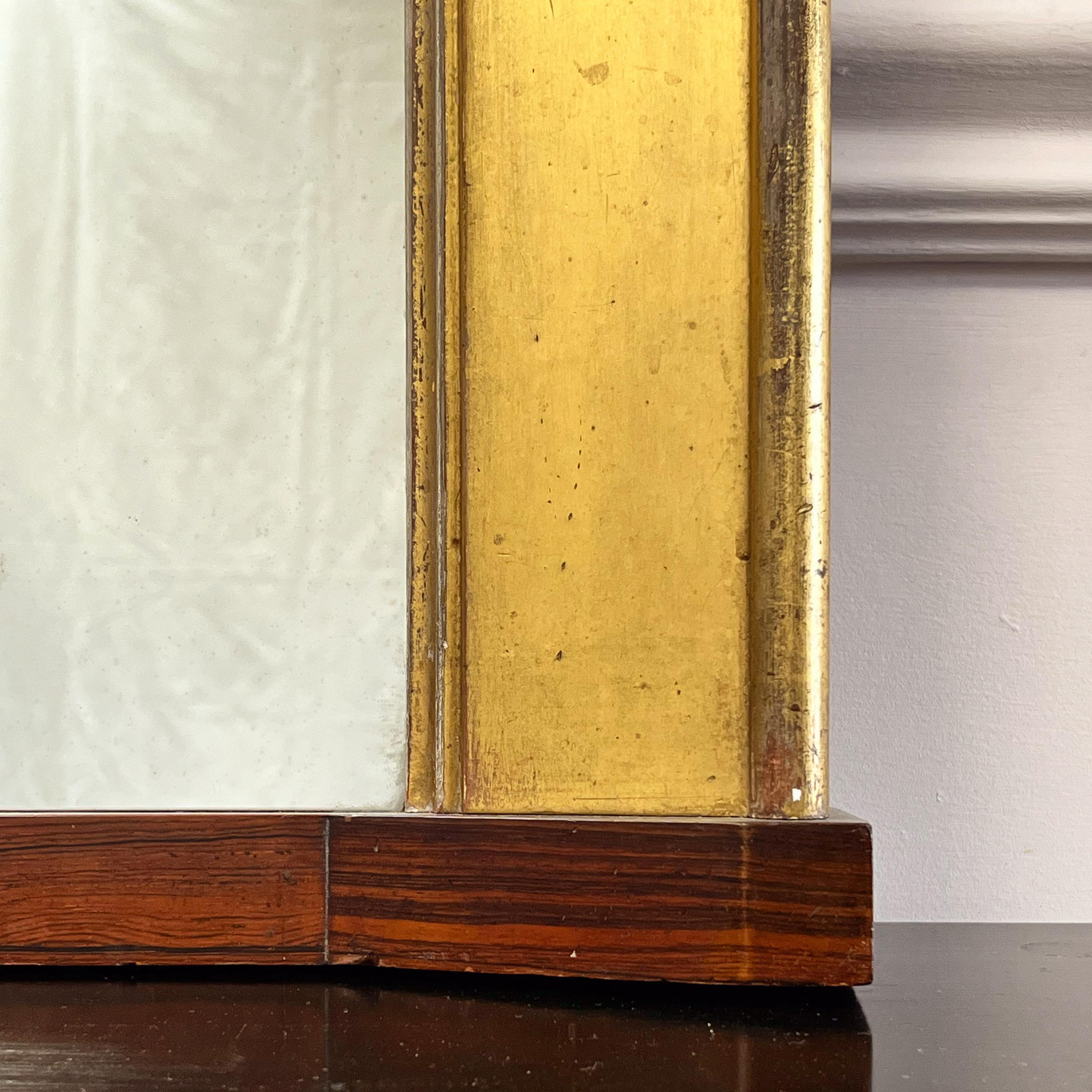 A very finely proportioned mantle mirror , the cantered border gilded all over and of exceptional colour with rosewood mount.

English, Early to Mid Nineteenth Century

H 107 x W 70 cms 
