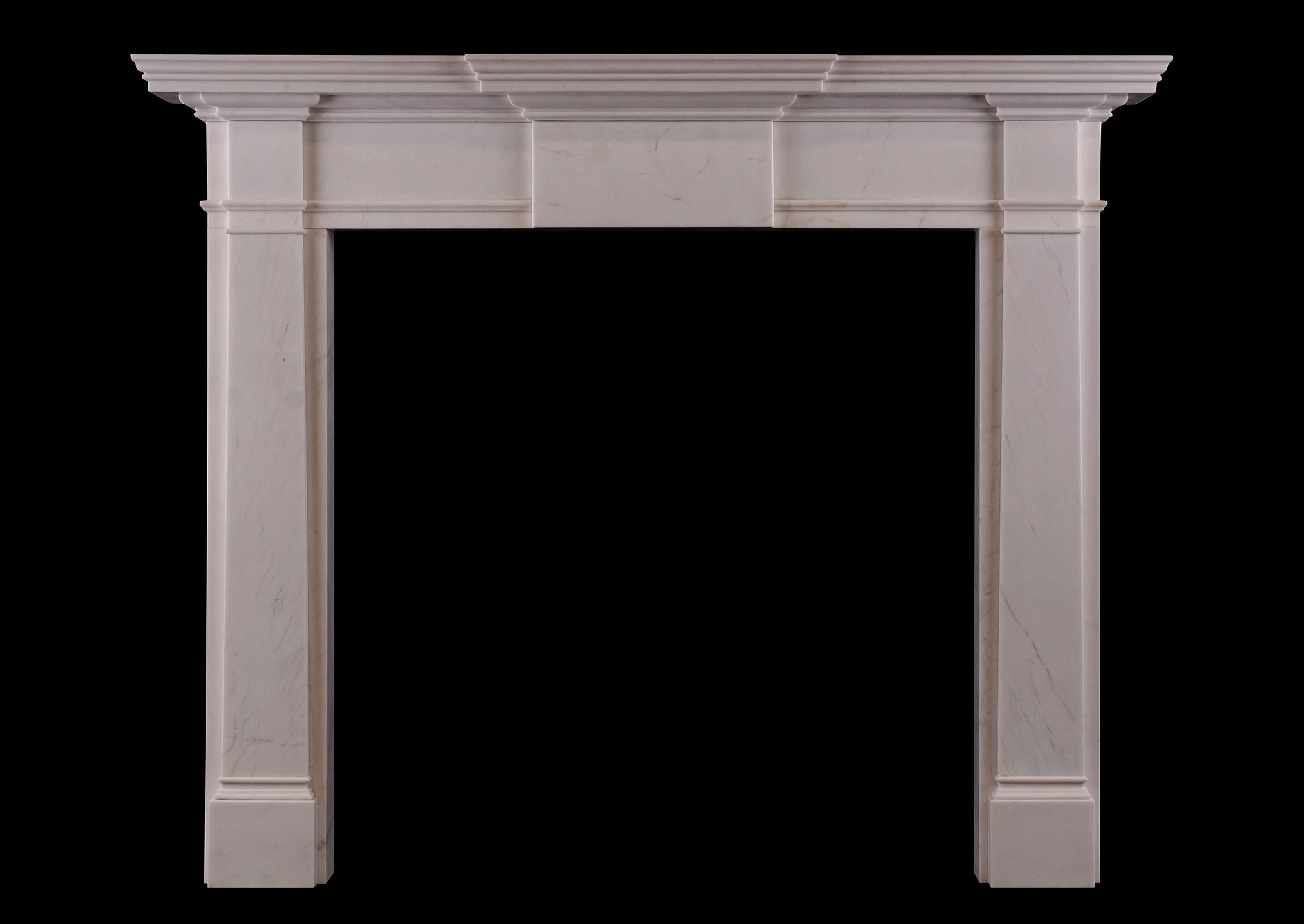 A mid-sized English Georgian style fireplace. The plain jambs surmounted by scotia moulding and plain end blocks. The frieze with plain centre panel with moulded shelf above. An attractively simple model in the classical style. Modern. (Smaller