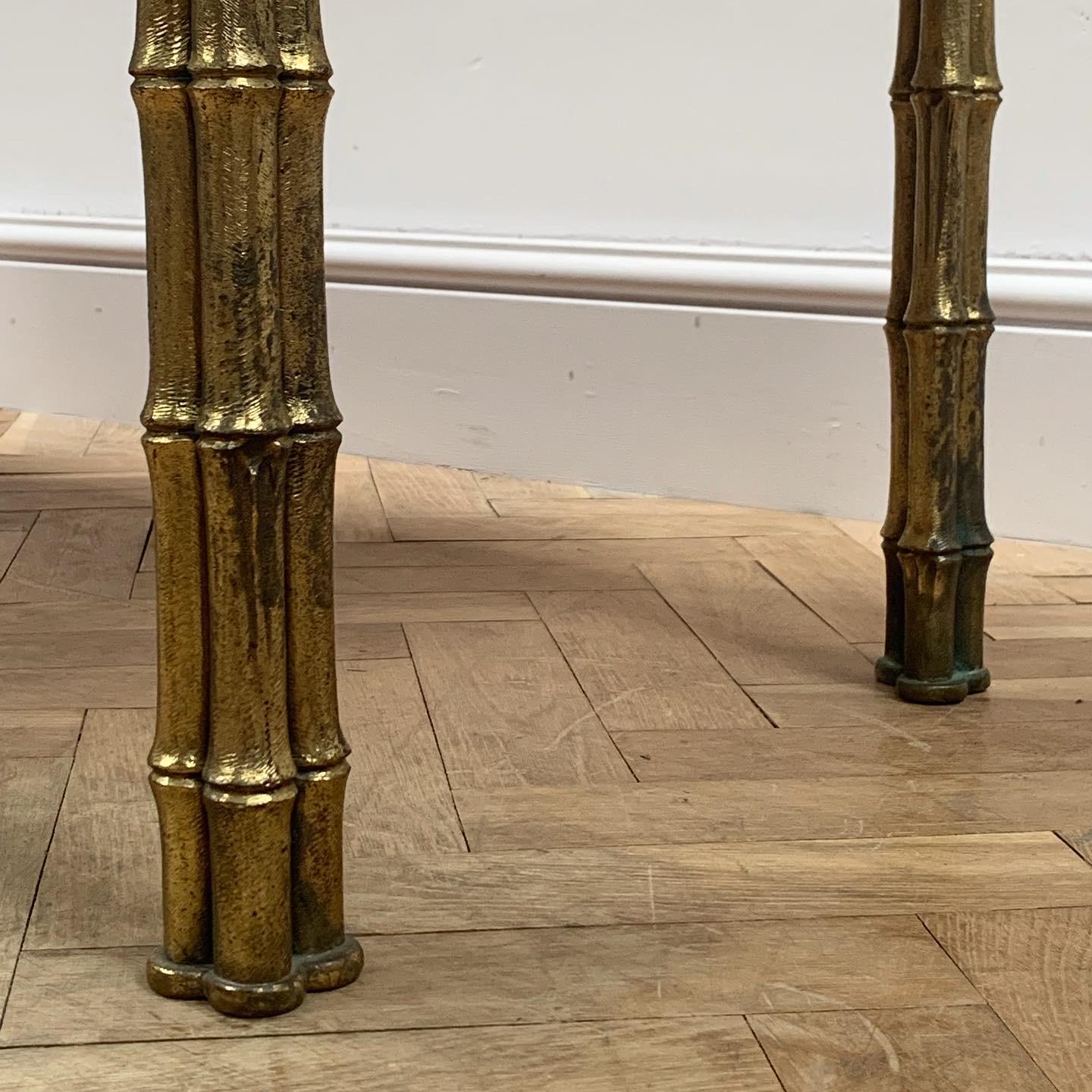 With specimen marble top having a central chess board inset, on four gilt brass faux bamboo tri-cluster supports, after Maison Bagues.

Continental, mid-twentieth century.
