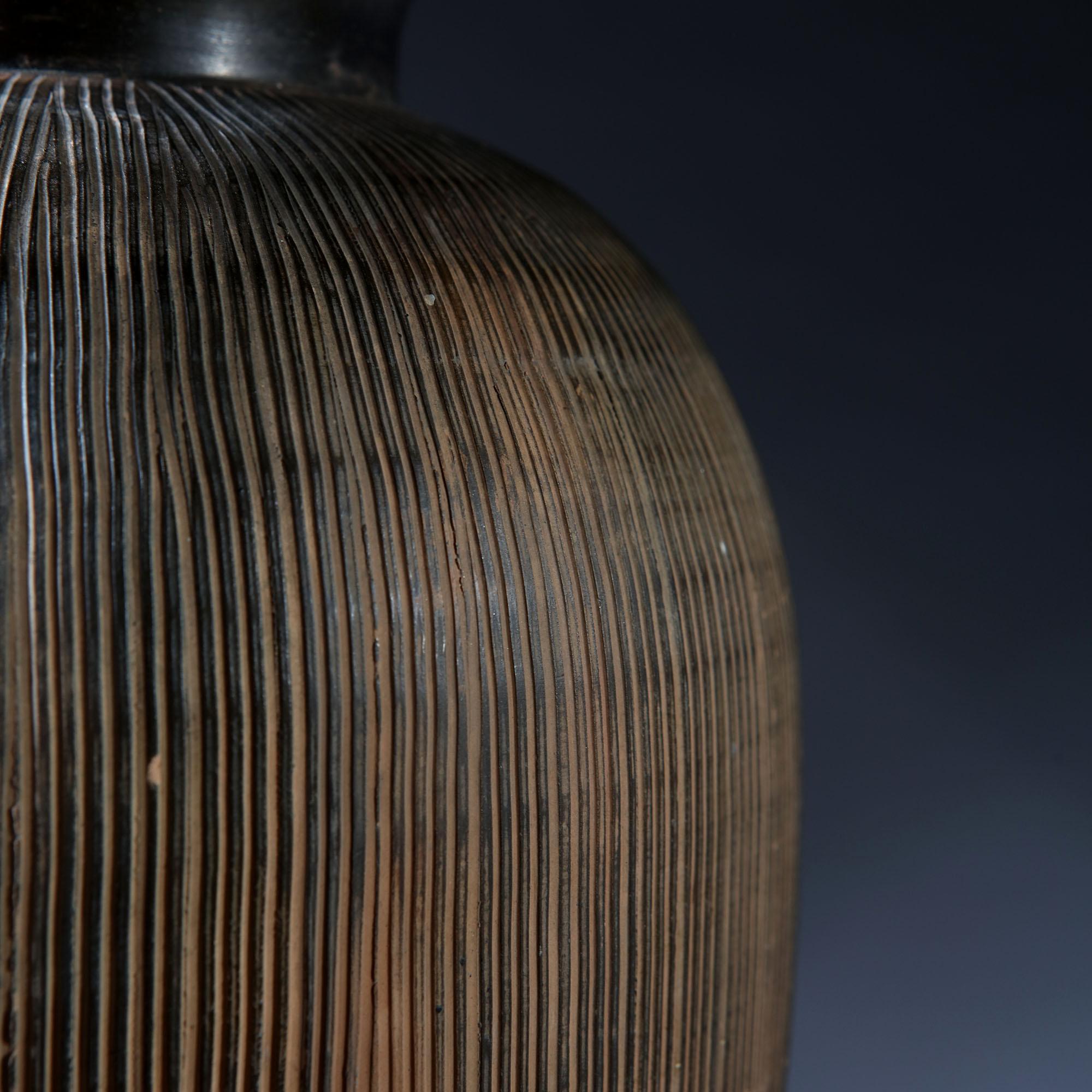 A mid-20th century Japanese ceramic vase, with ribbed rich brown glaze throughout, now converted as a lamp.

Please note: lampshade not included.

Currently wired for the UK.