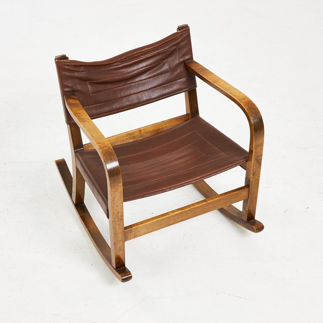 This unique Swedish Mordern rocking chair echoes the designs of Axel Einar Hjorth and Goran Malmvall. Whilst the designer is unknown, the nearly century old chair, made from solid birch, has a beautiful patina and is in excellent condition. 

For a