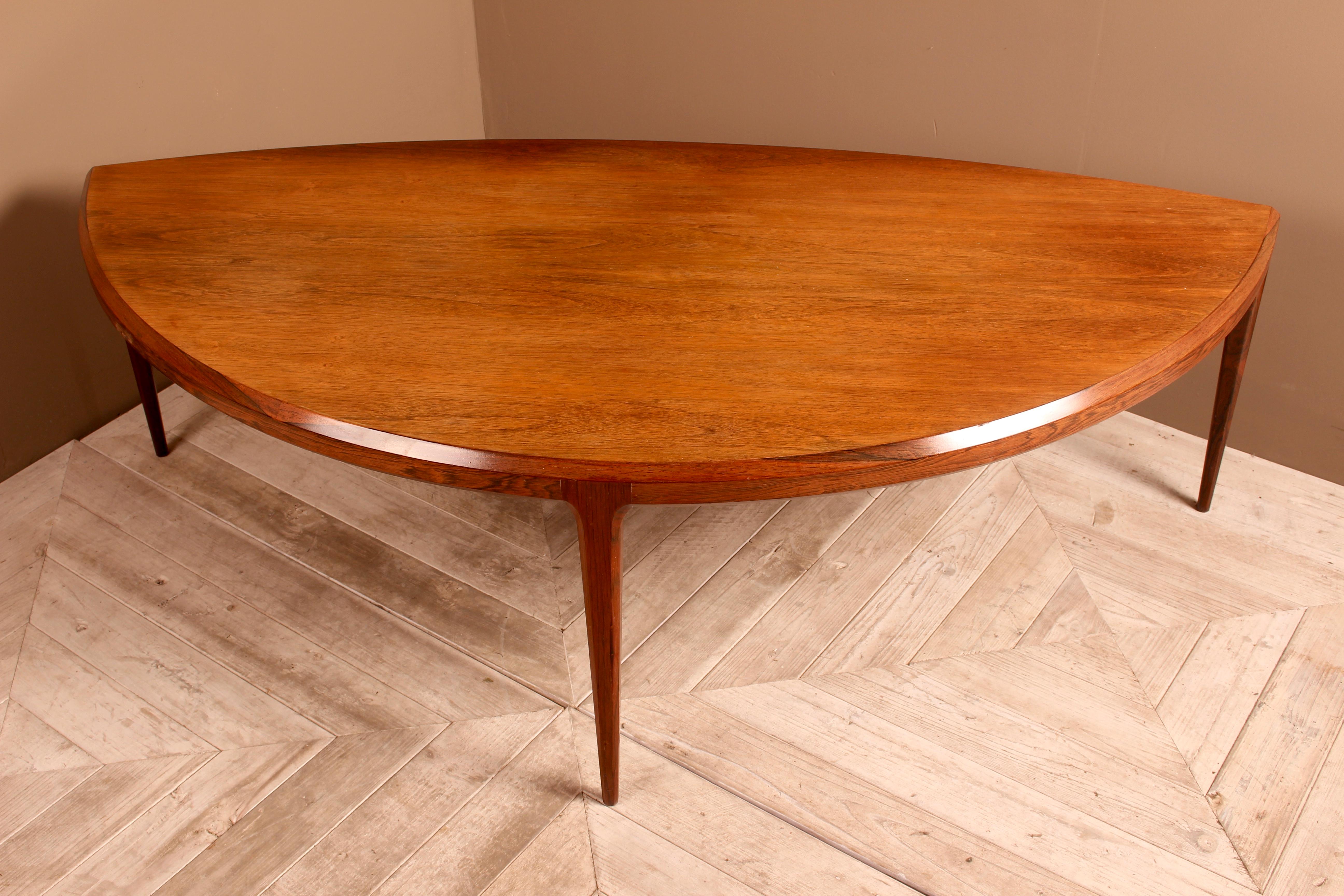An attractive midcentury coffee table of demilune design made by the Danish firm CFC Silkeborg and designed by Johannes Anderson in the 1960s. Formed in the shape of an eye and having attractive chamfered edges to the tabletop and legs. The whole