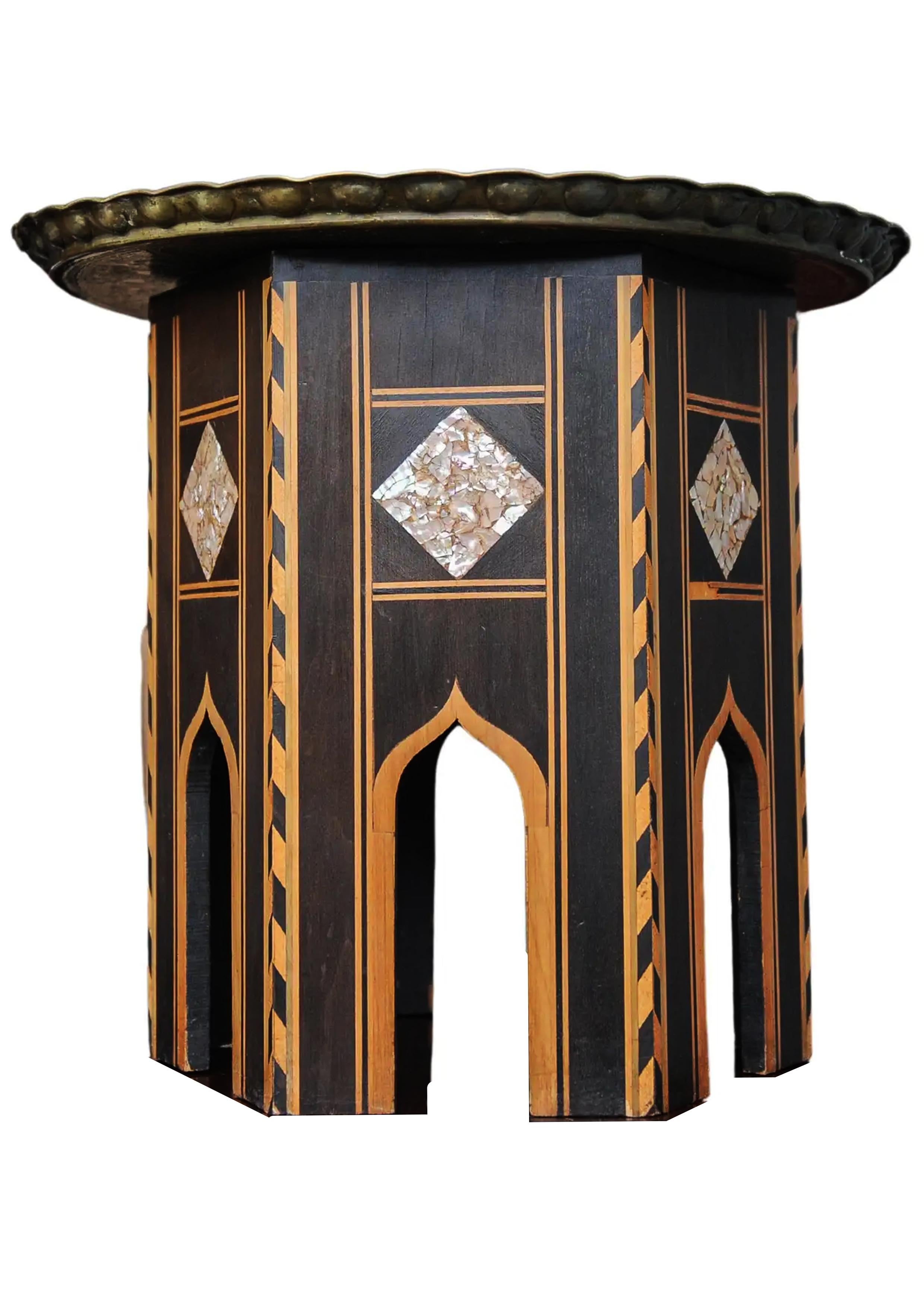 A Middle Eastern Antique Ebonised Tea Table With Removable Brass Decorative Pie Crust Edged Tray Top And Beautiful Inlay

Full Height 51cm
Base Width 41cm
Brass Tray Diameter 58cm