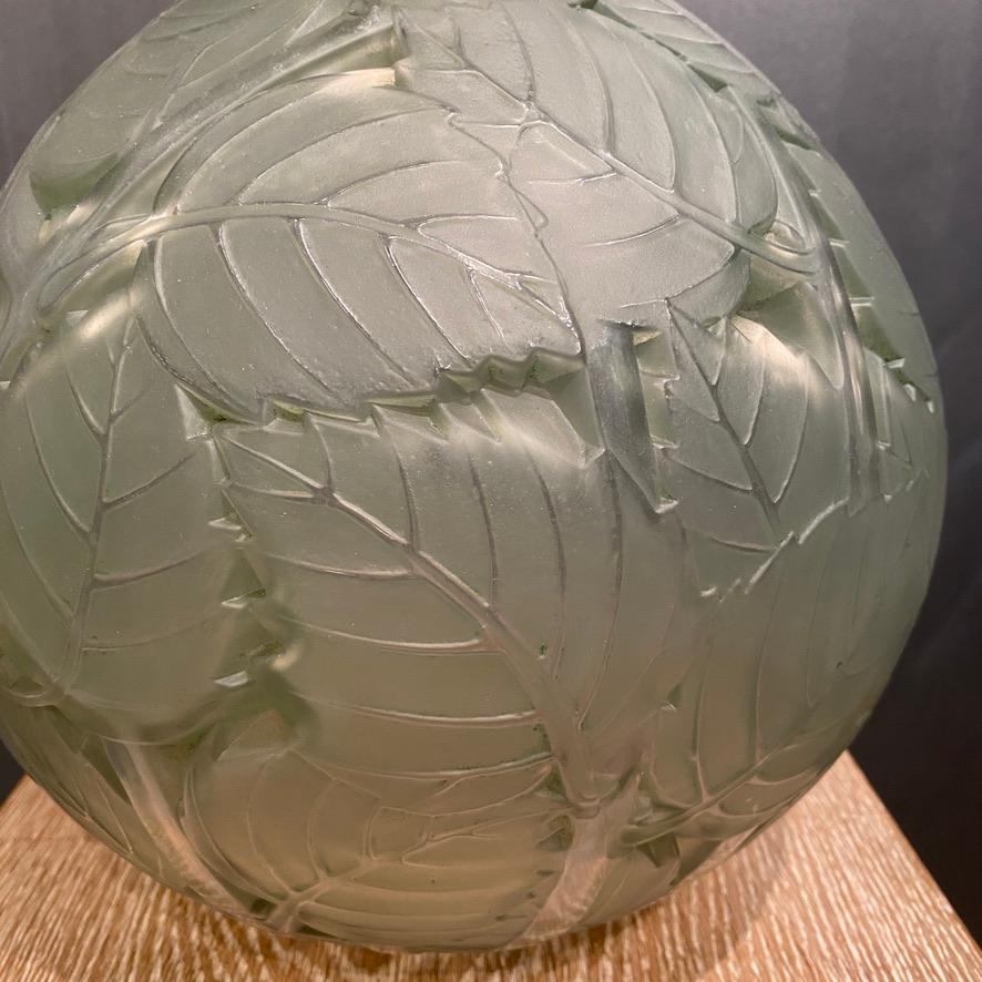 The Milan vase was created in white glass by R.Lalique in 1929.

The example is in perfect condition and has a light green patina .

The vase has an overall decoration of leaves .

R Lalique 's habit was to study the nature as many of the art