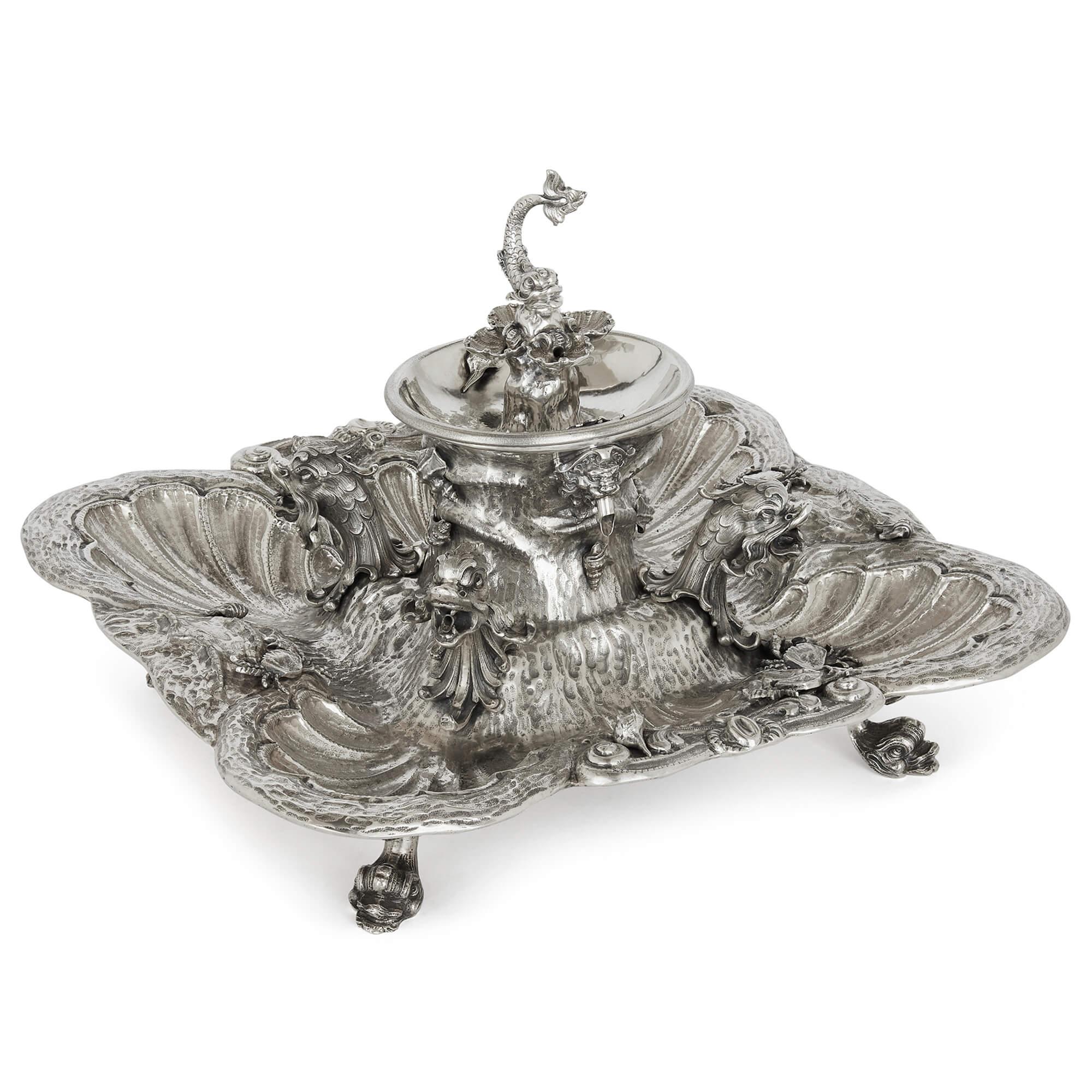A Milanese sterling silver 20th century fountain centrepiece
Measures: Height: 33cm, width: 47cm, depth: 42cm.

This stunning centrepiece is an Italian sterling silver fountain, made in Milan in the twentieth century. The piece, set on