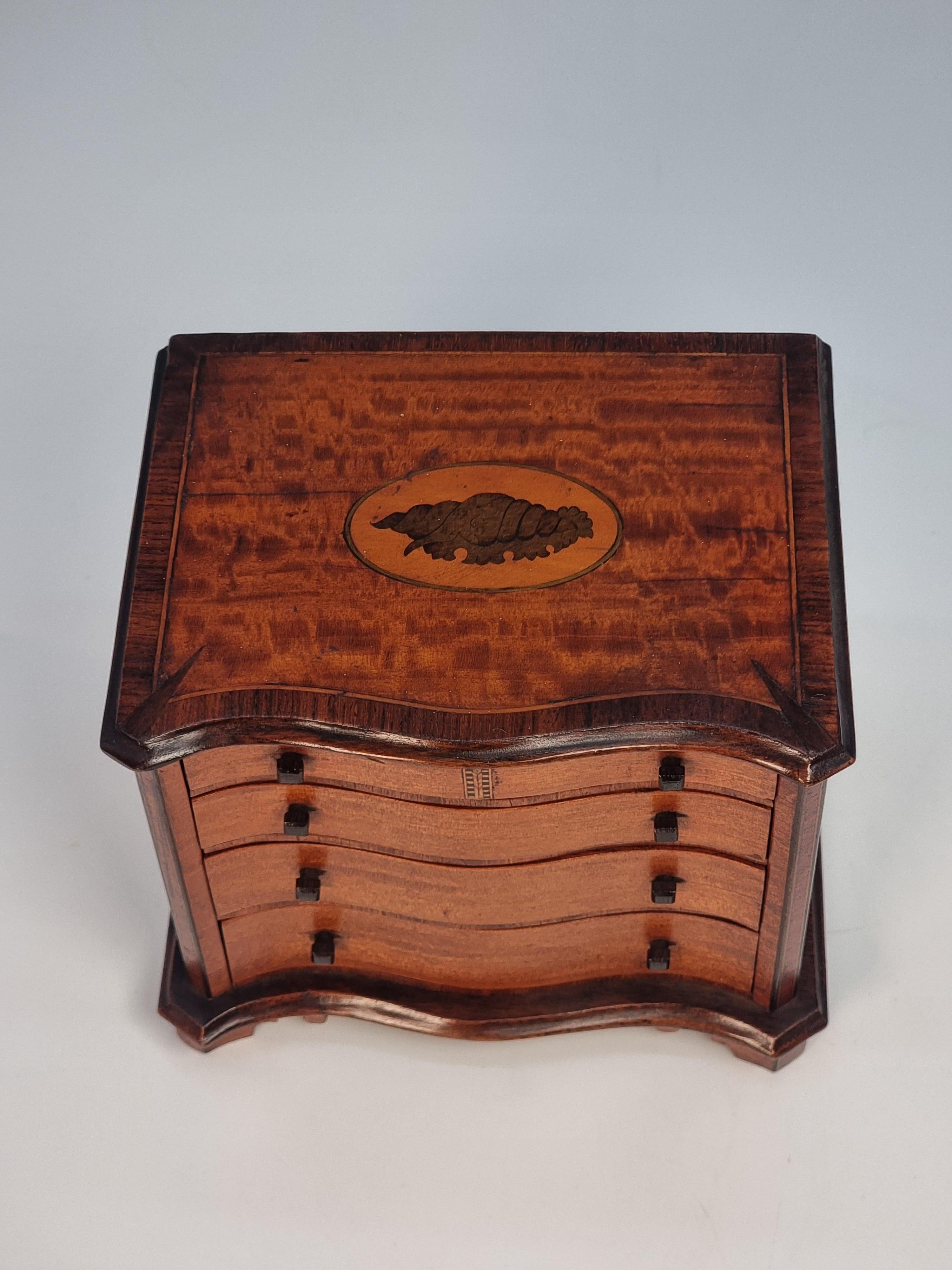 Mahogany A miniature 18th C style mahogany English serpentine chest of drawers 1907 For Sale
