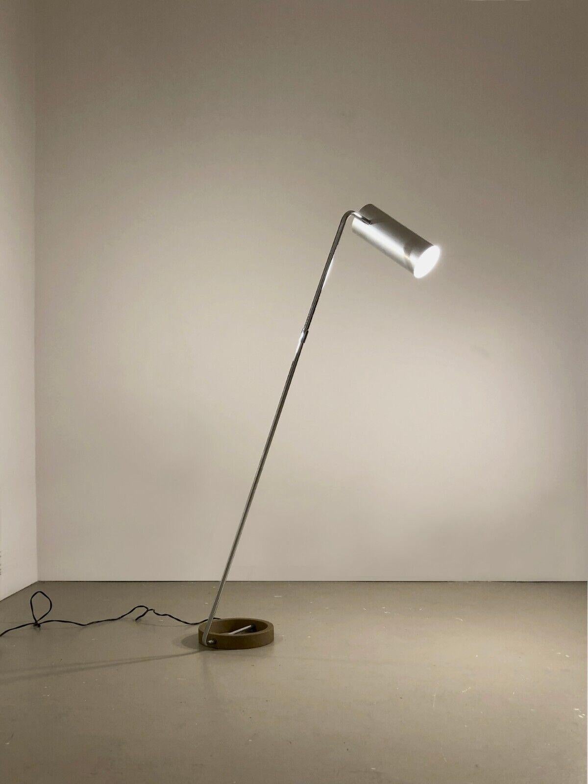 A small adjustable floor lamp or reading light, Post-Modernist, Minimalist, circular base in brown granite cast iron, vertical axis adjustable at the base and at the top, cylindrical lampshade in brushed aluminum with integrated switch also