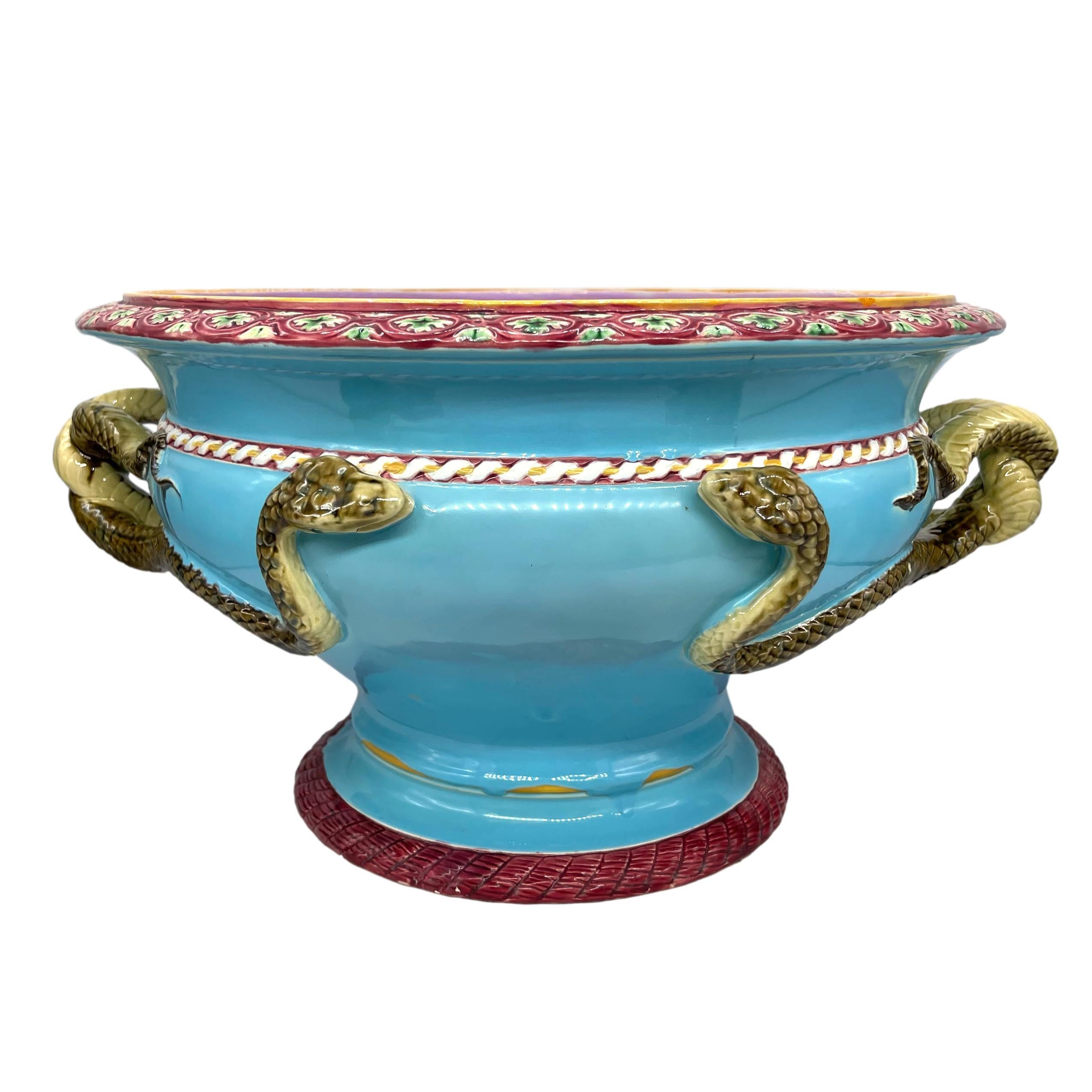 A Minton Majolica Large Turquoise Ground Jardinière Designed by Gottfried Semper (German 1803 -1879), the ovid-form body applied with entwined snakes forming the handles, the rim with a Renaissance-style band of oblong chain-work reserves with green