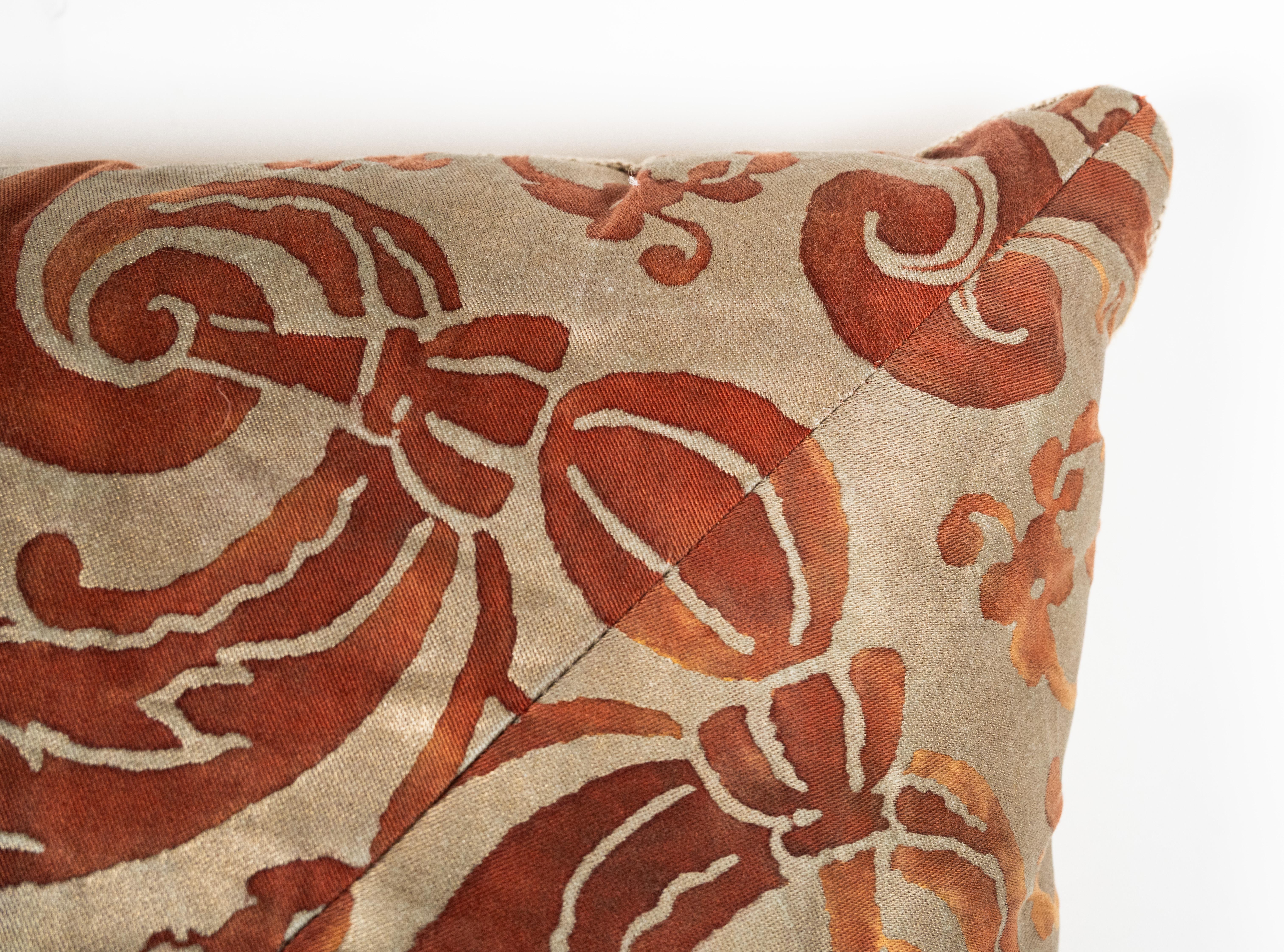 A Mitered Fortuny cushion in the Carnavalet pattern, featuring a red and silvery-gold color way.