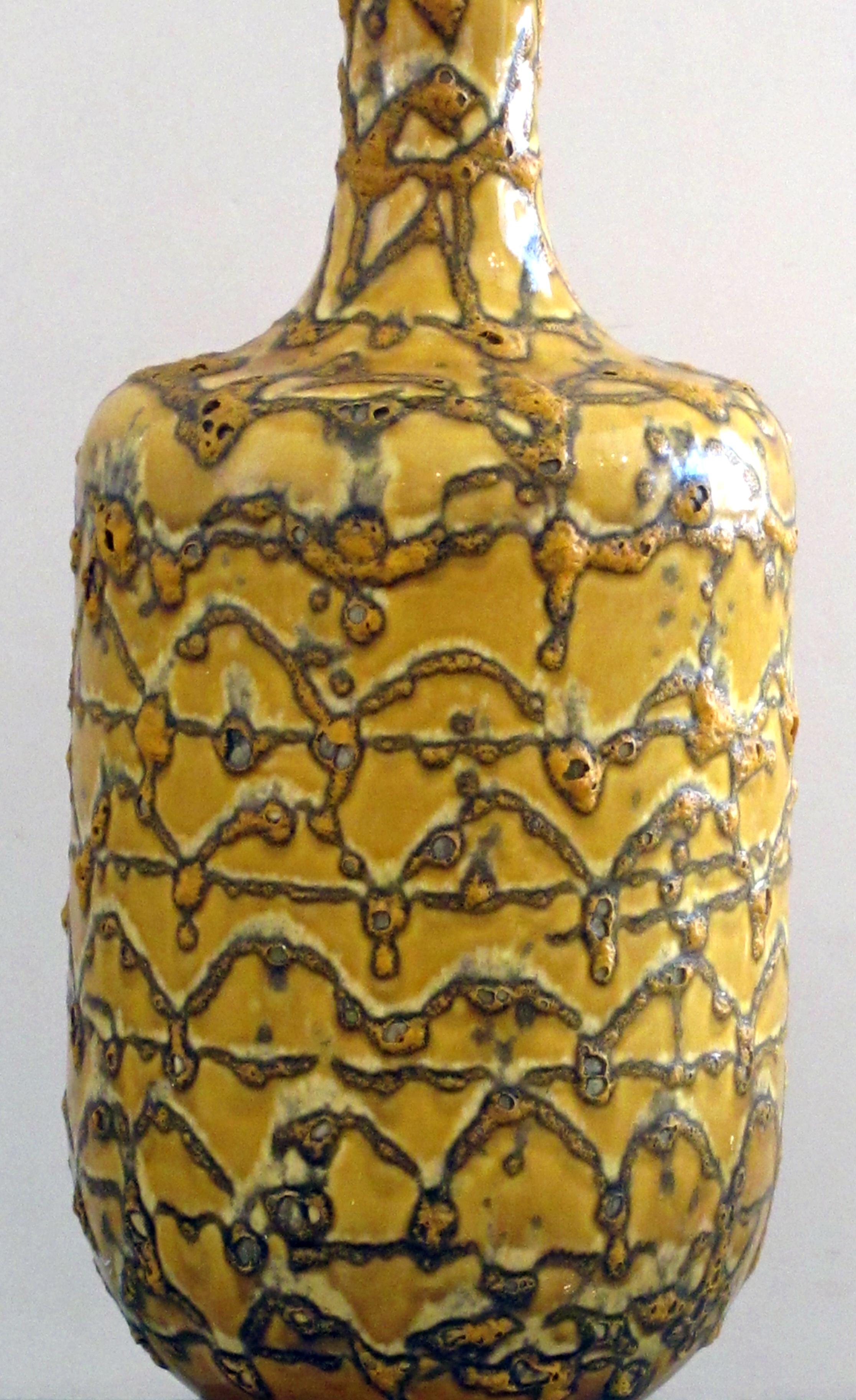 The large bottle-form lamp with long neck and tapering body all in a crater glaze.