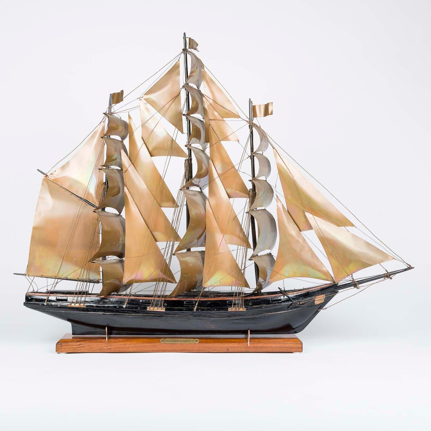 A model of a three mast sailing ship Golden Horizon, circa 1920.

Copper sails and rigging, ebonized oak hull, masts, deck and fittings.

Stand with brass name plate: GOLDEN HORIZON

 